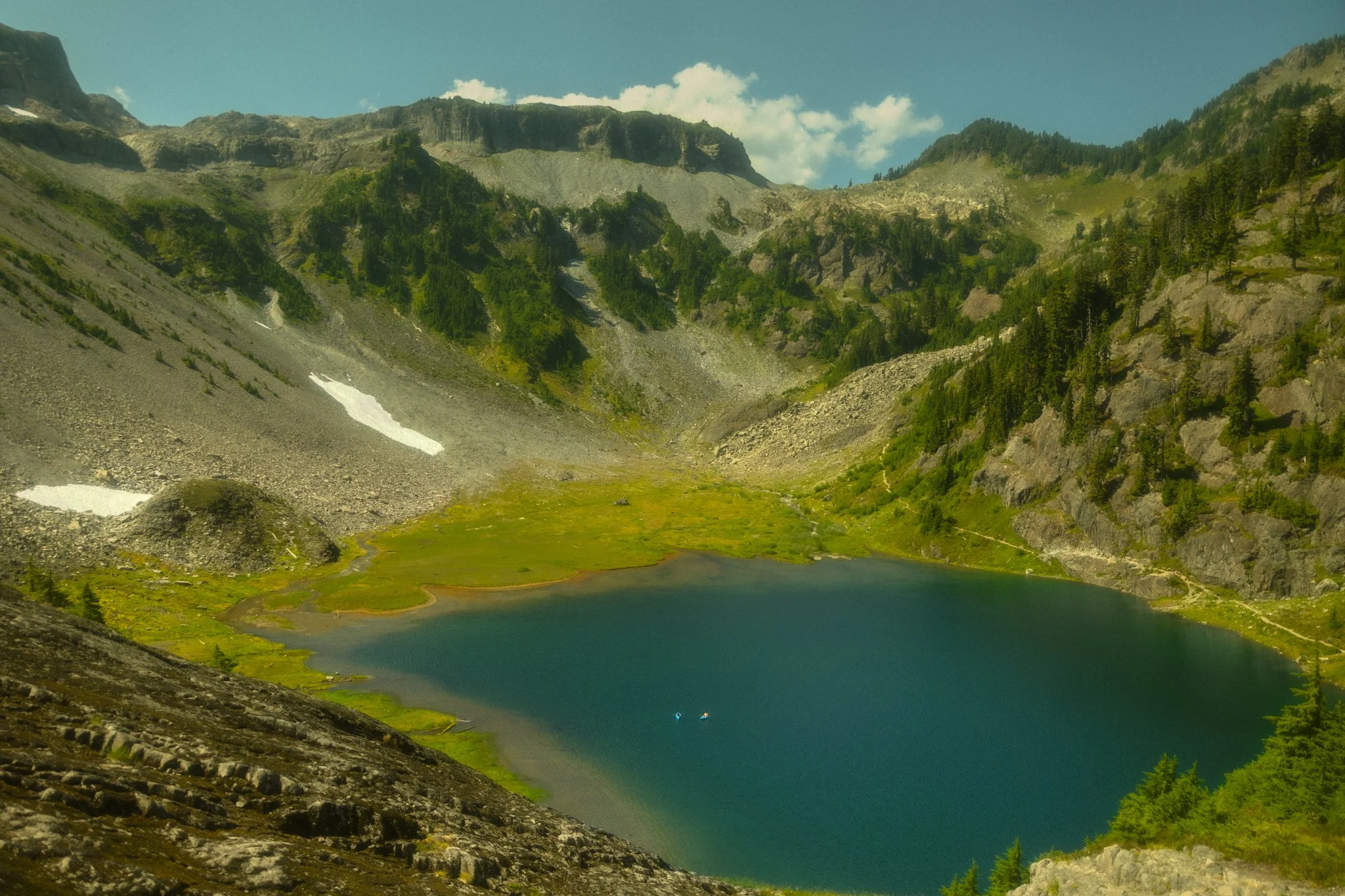 an elopement couple pack rafting on a lake in the Mt Baker region