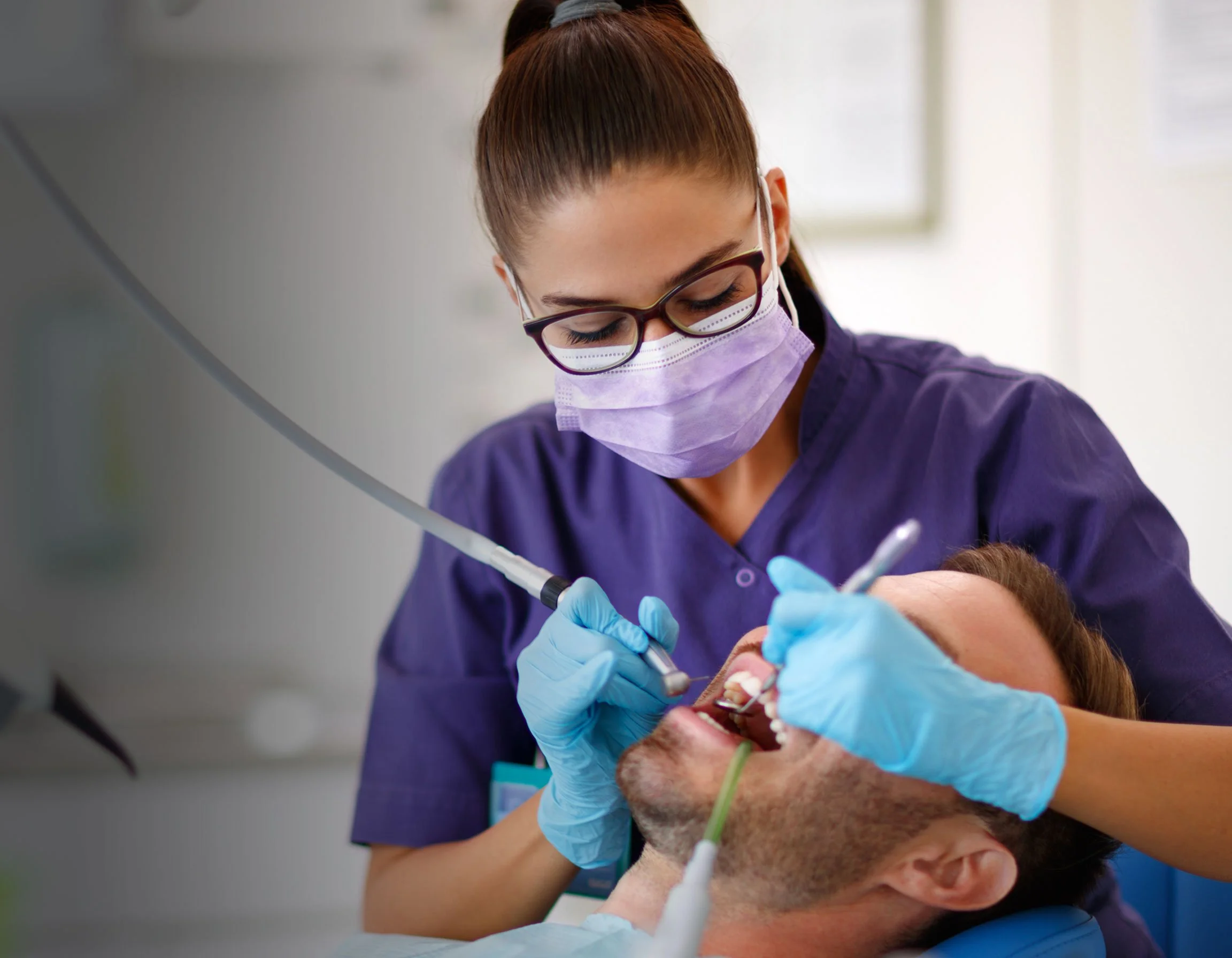 Dental Clinician with dental handpieces