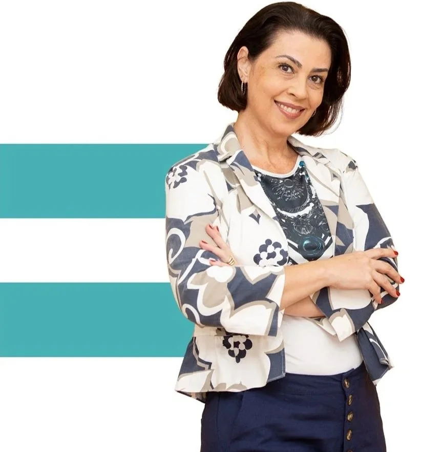 smiling middle aged nonprofit leader standing confidently with her arms crossed