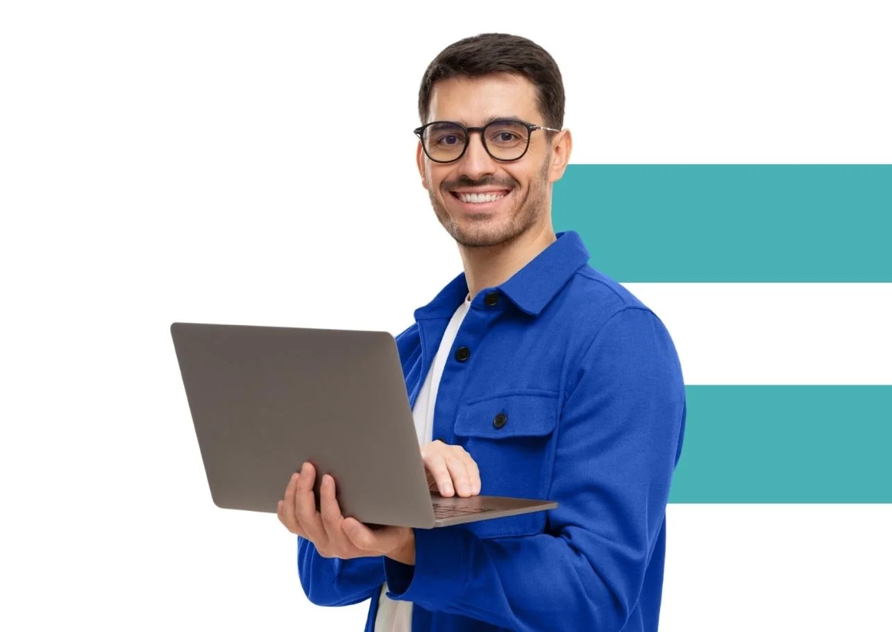 Nonprofit professional in blue shirt holding laptop and smiling.