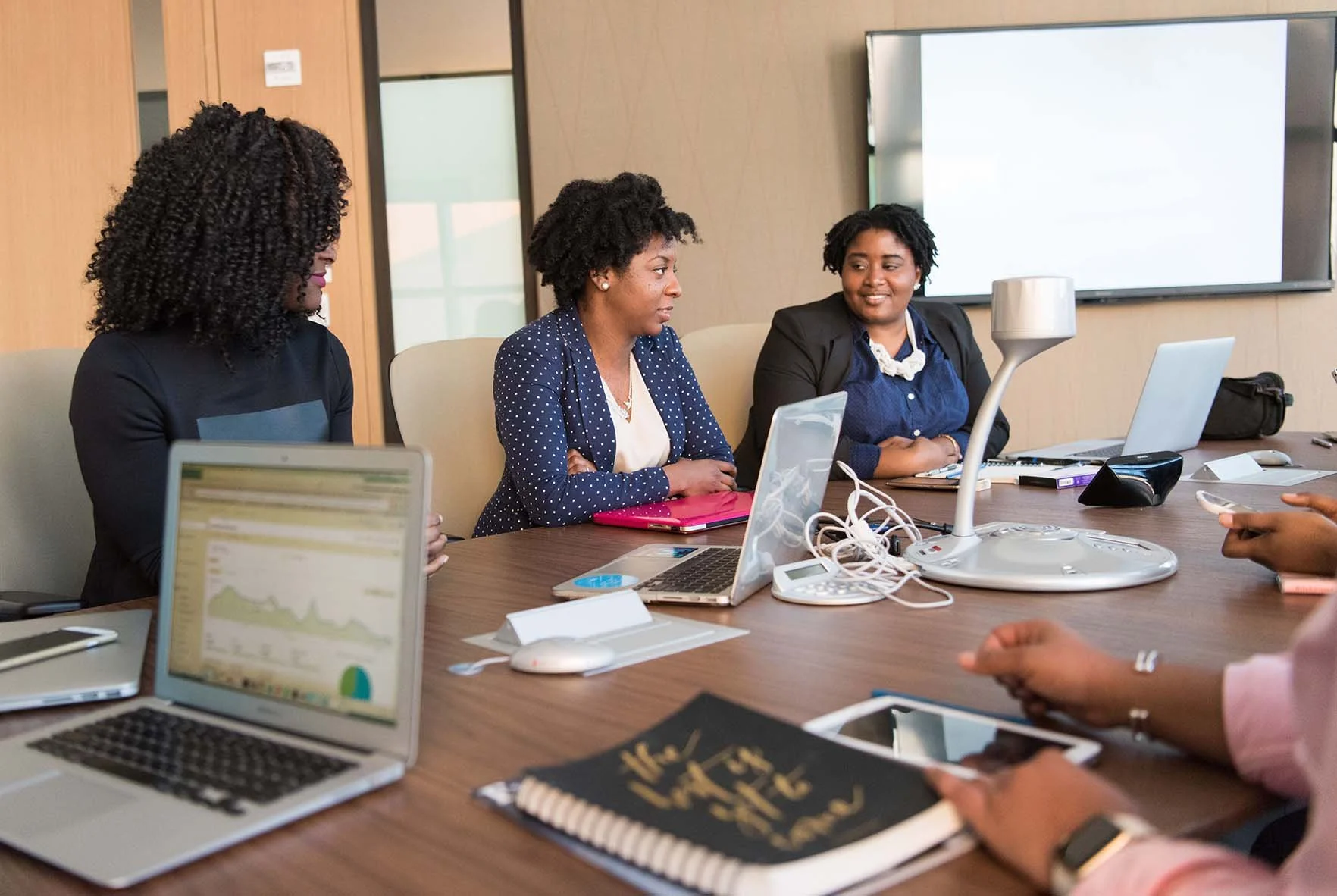 nonprofit board sitting in a meeting room having an engaged discussion