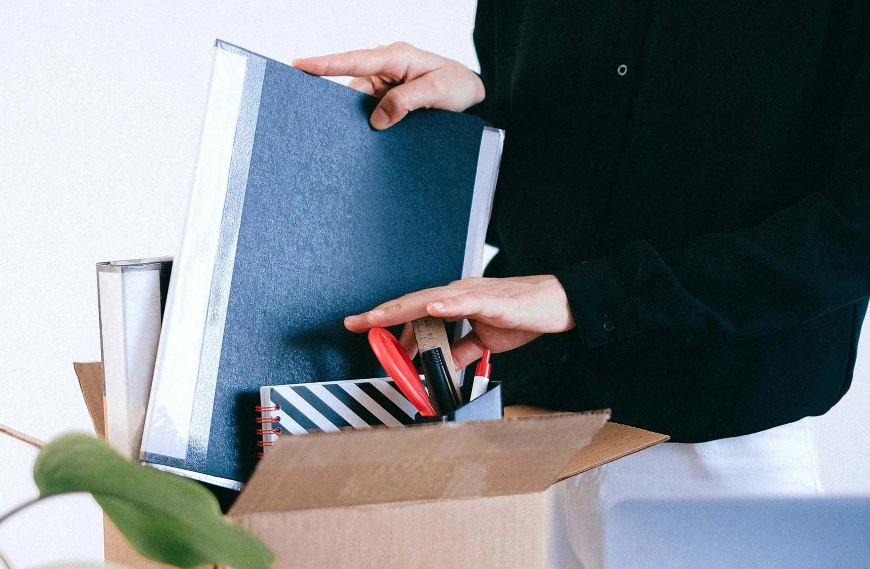 nonprofit employee packing up their desk and putting their belongings in a box