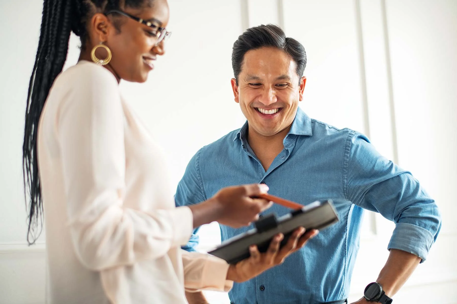Nonprofit account expert smiling while showing nonprofit executive directive financial report on tablet.