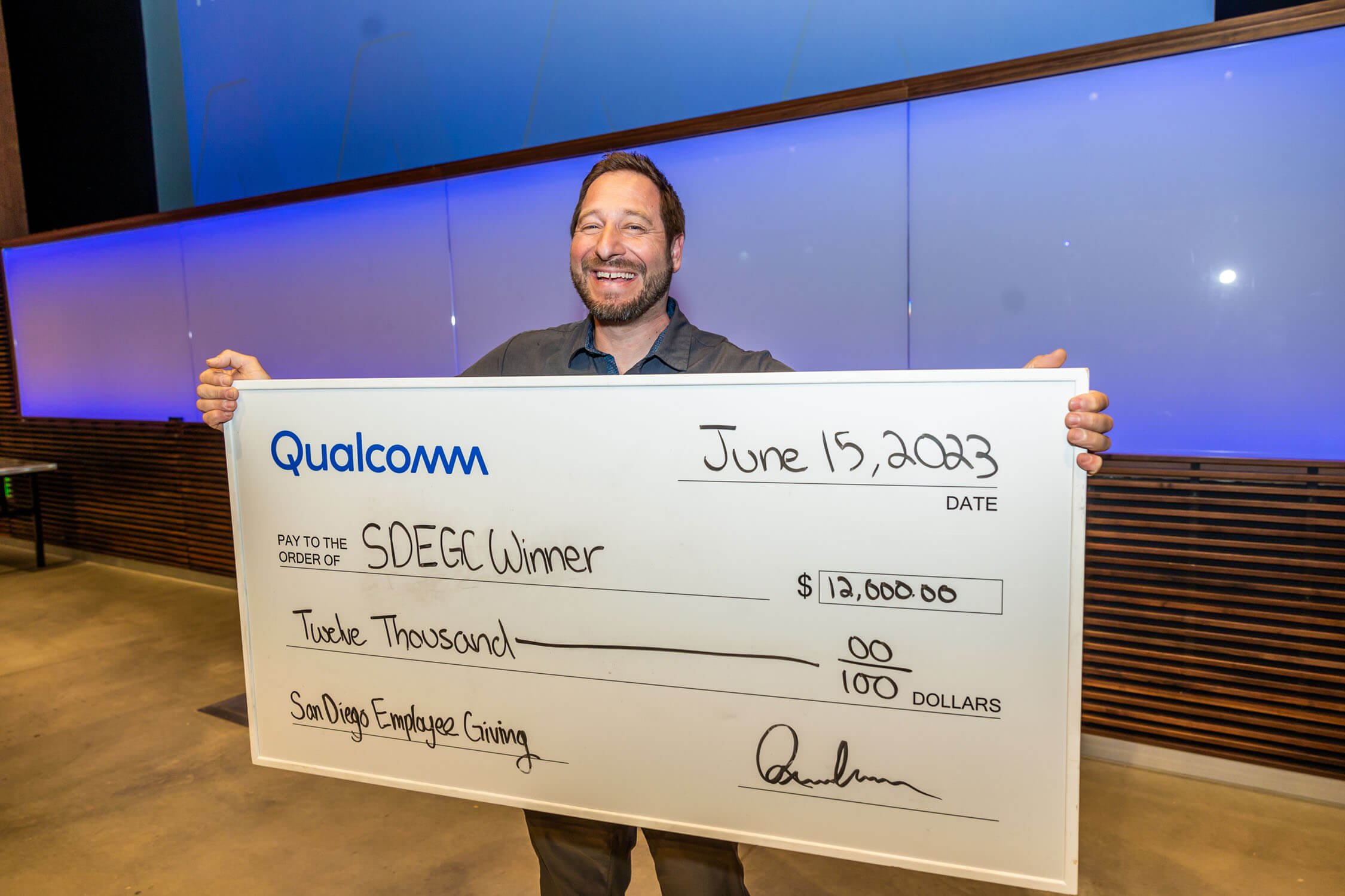 Qualcomm-SDEGC-Winner-holding-giant-check-for-twelve-thousand-dollars.jpg
