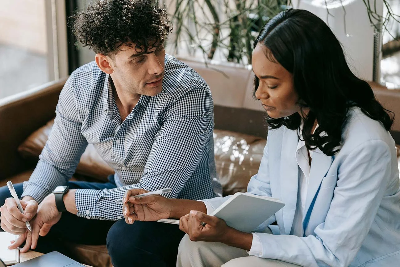 nonproft team meeting with woman writing in notebook