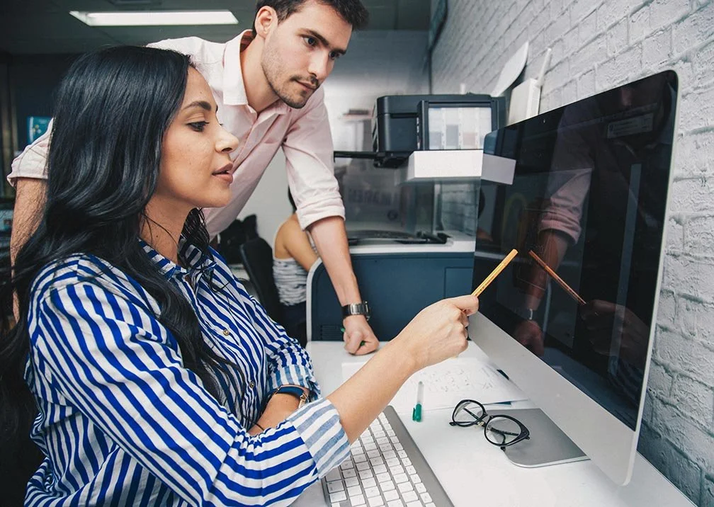 corporate social responsibility team doing systems walkthrough on computer in office