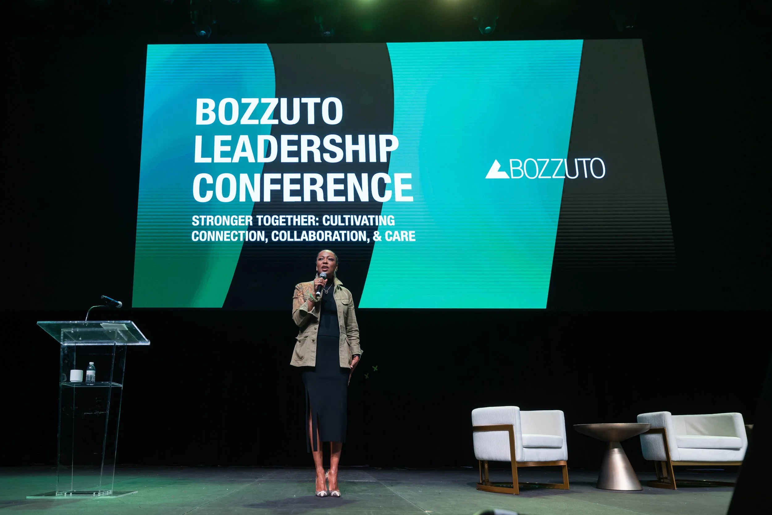 Woman on stage giving a speech at the Bozzuto Leadership Conference in Maryland. Event produced by Washington D.C. based event agency Stratus Firm