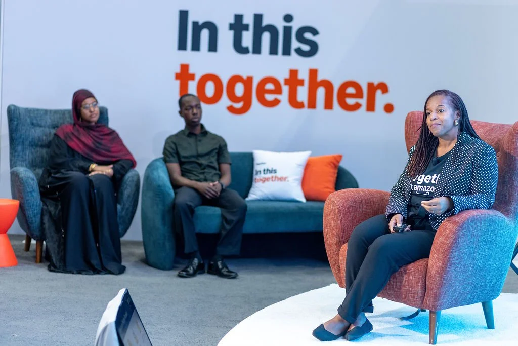 Woman seated on stage giving a talk at the Amazon lounge during the Congressional Black Caucus Foundation's Annual Legislative Conference 2025