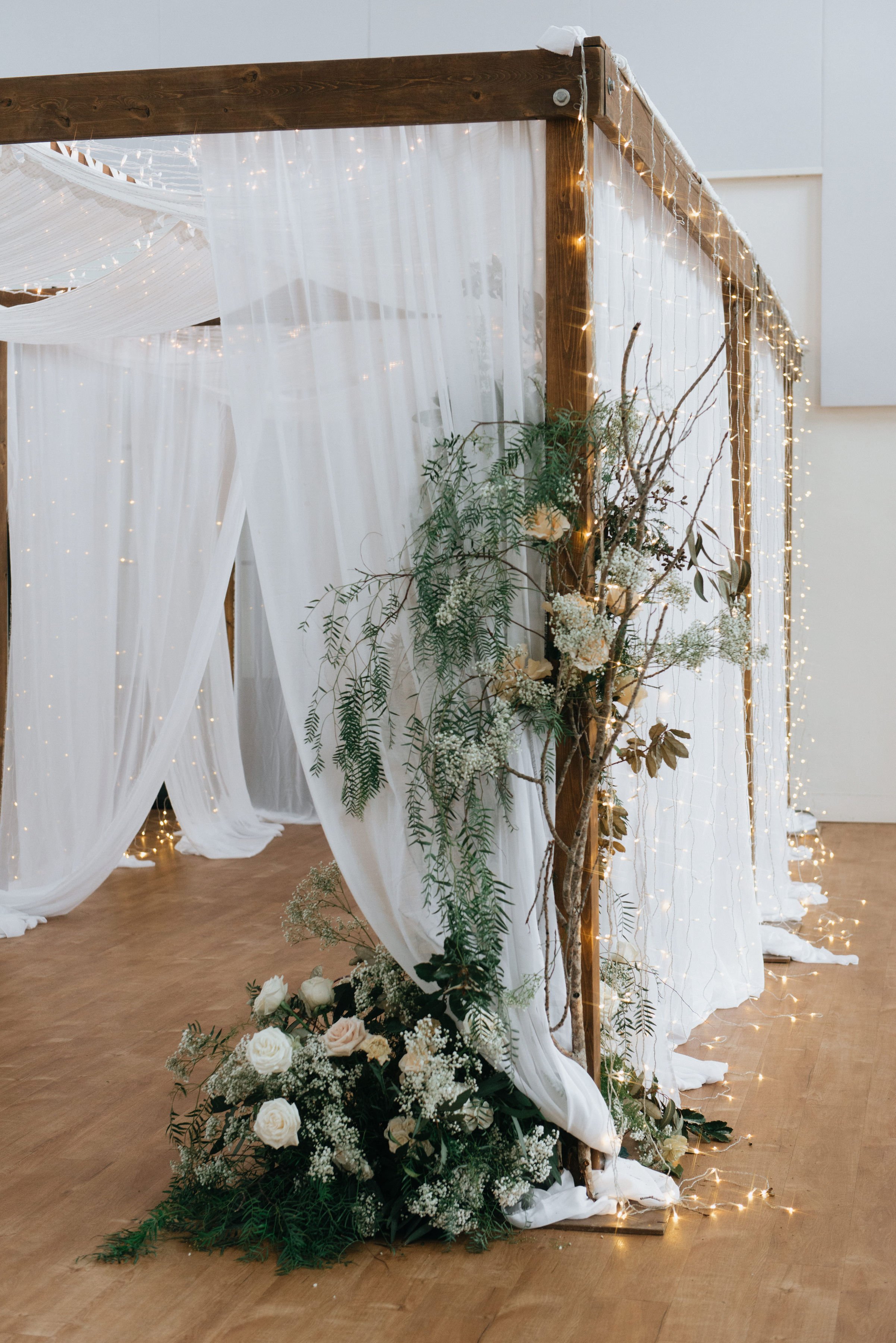  The gals transformed the entrance from our foyer into the main space with a canopy of twinkle lights and floral arrangements to die for.  