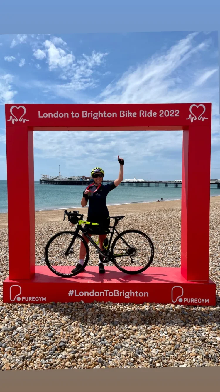 Sammy with her bike at the London to Brighton bike ride finish line