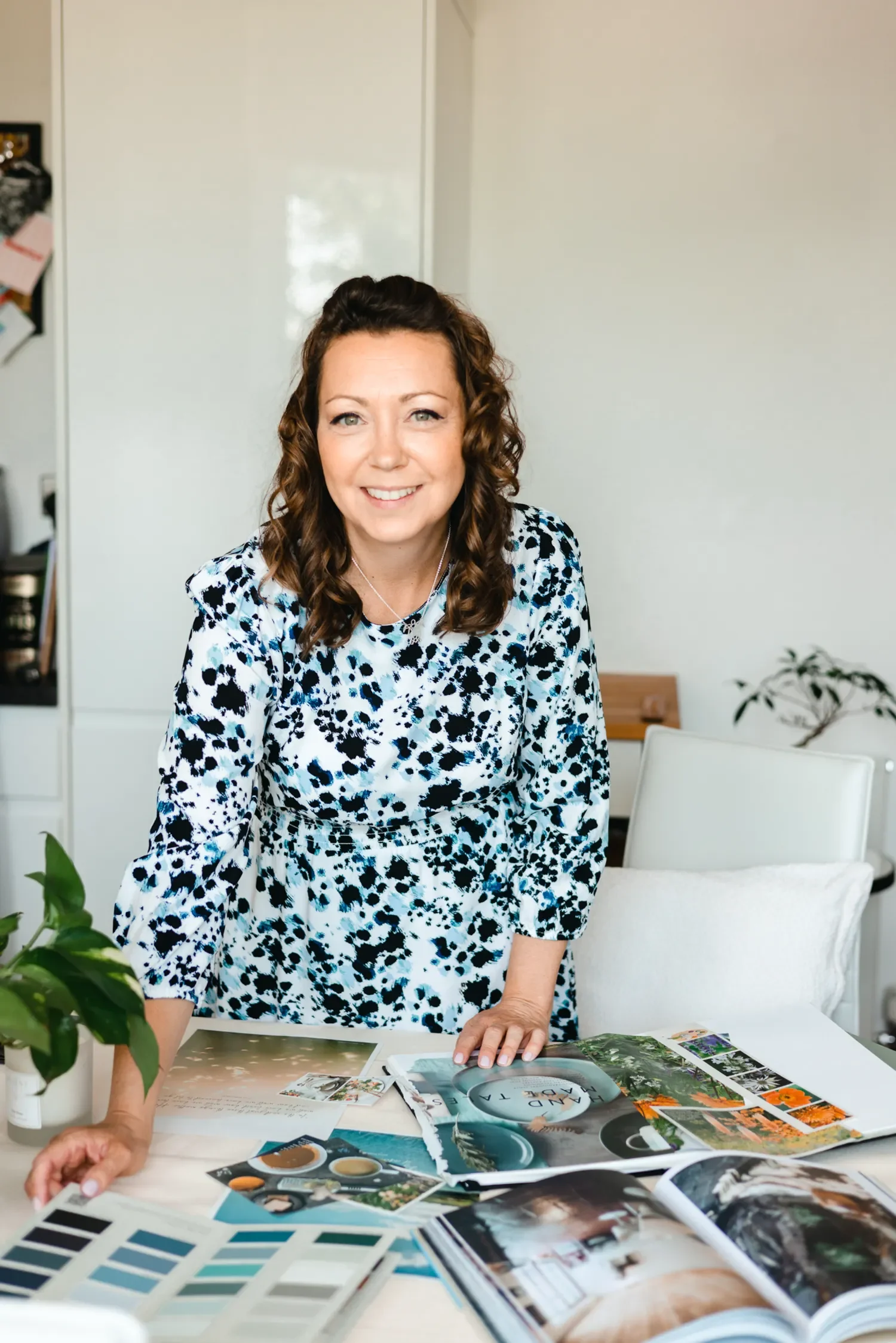 Sammy Phillips arranging a mood board using magazine cut-outs