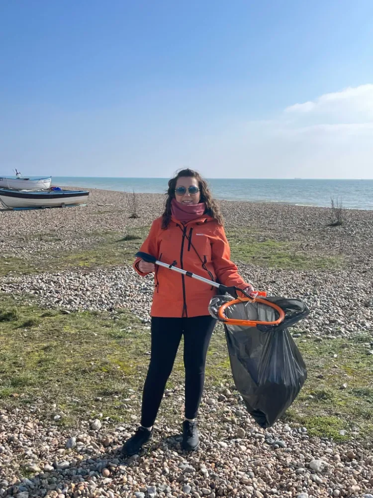 Sammy on the beach with litter pick during Beer No Evil beach clean in Worthing