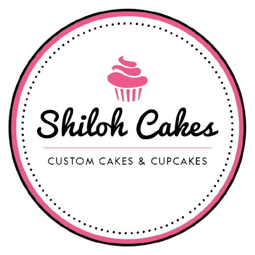 Logo for Shiloh Cakes, featuring a pink cupcake illustration above the business name in script font, with the tagline "Custom Cakes & Cupcakes" below, all within a pink-bordered black circle.