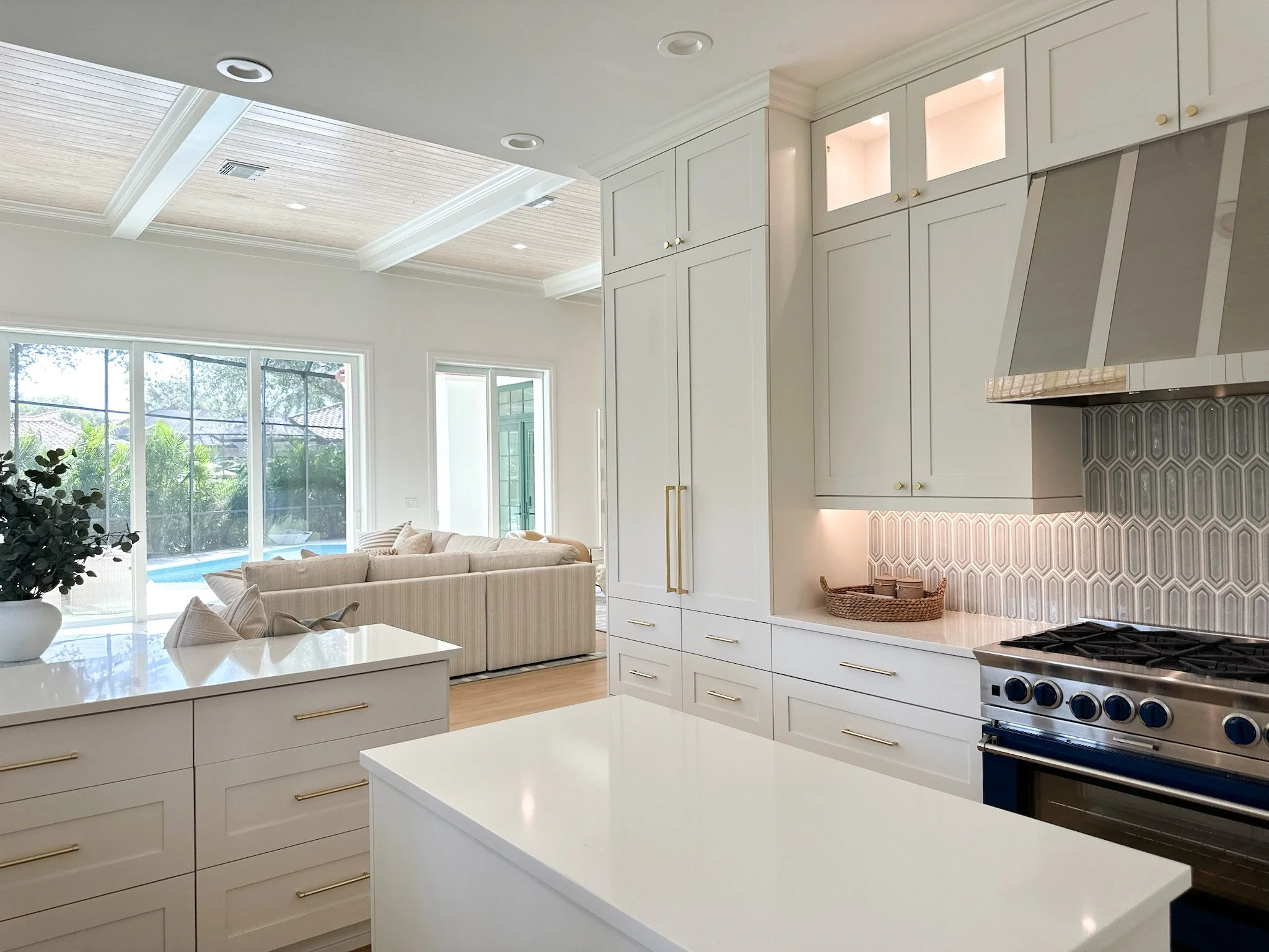 Open concept kitchen with geometric backsplash, brass cabinet pulls, featuring a neutral coastal design by Lark and Soul design.