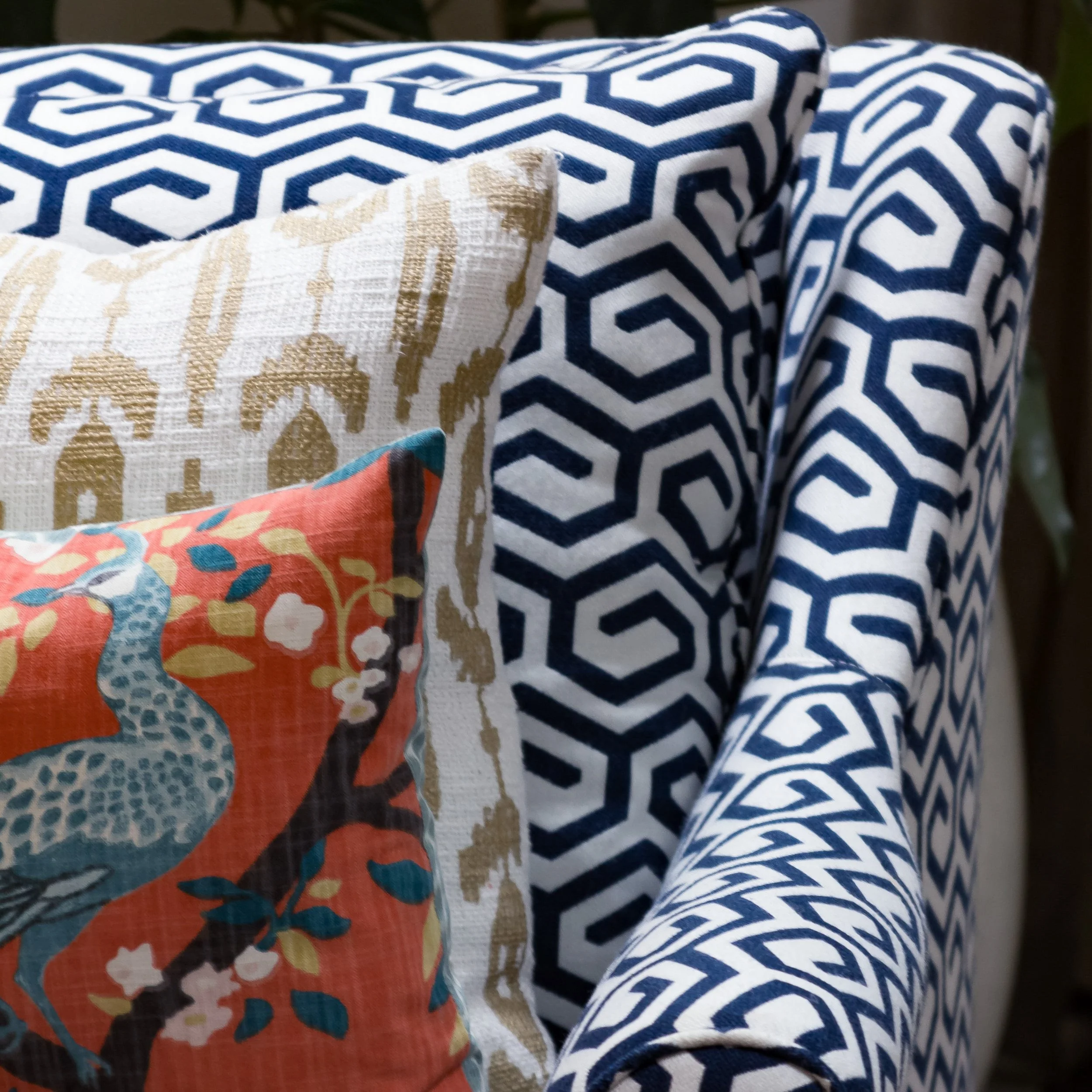 Duxbury Antique family room with four blue and white patterned and colorful pillows by Lark and Soul interior design