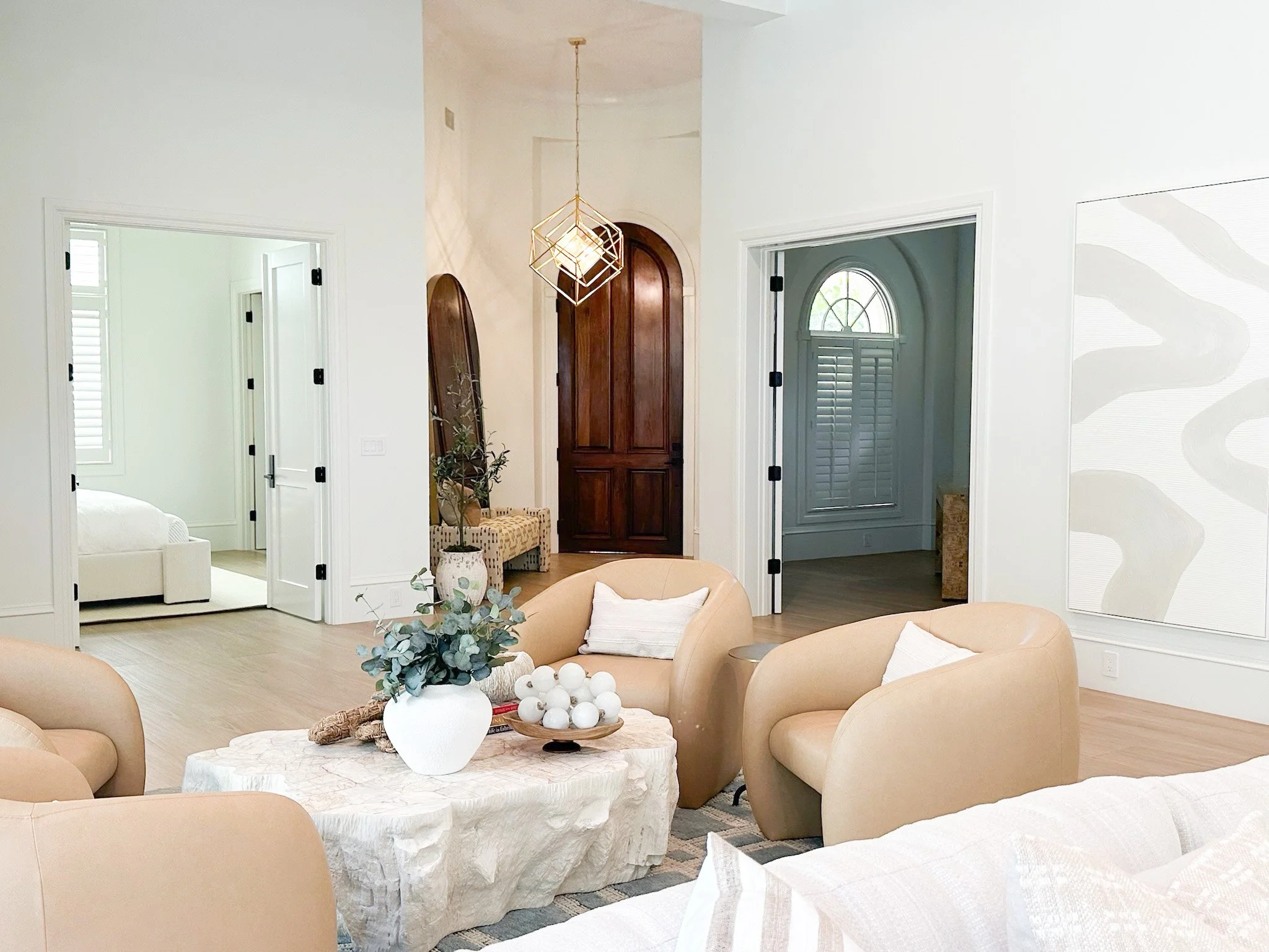 Living room seating area featuring four modern light brown chairs styled by Lark and Soul interior design in Naples Florida