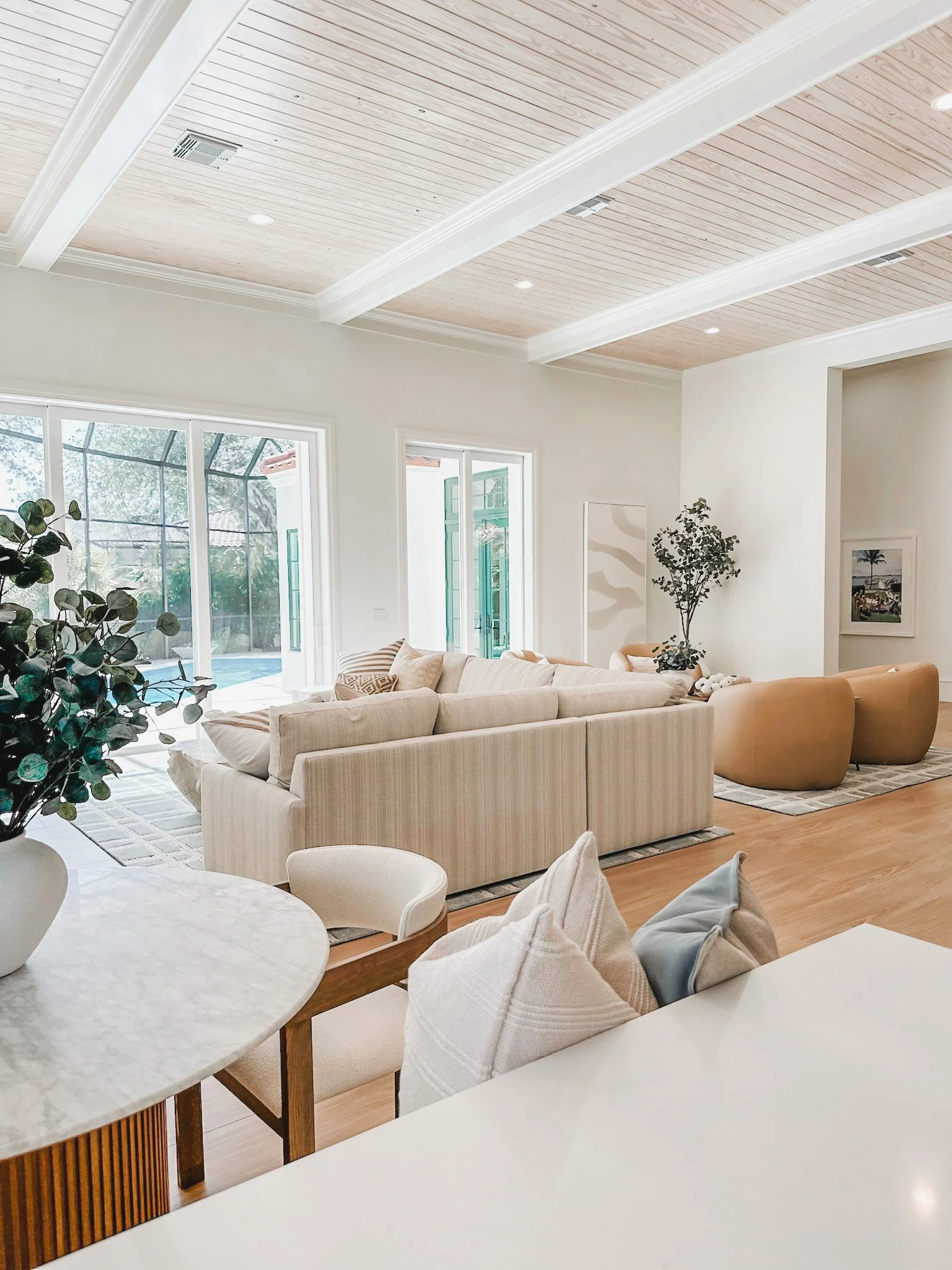 Lark and Soul interior design- open concept kitchen and family room with neutral coastal design inNaples Florida.