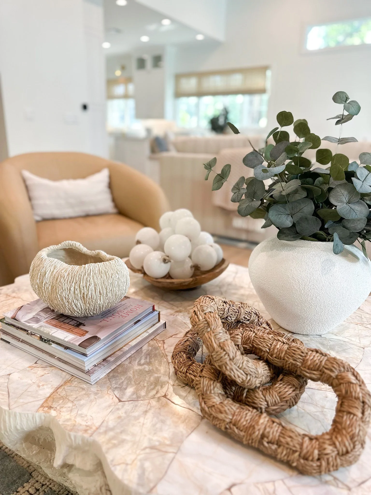 Coffe table styled by Lark and Soul Interior design featuring eucalyptus plant and coastal accent pieces in Naples Florida