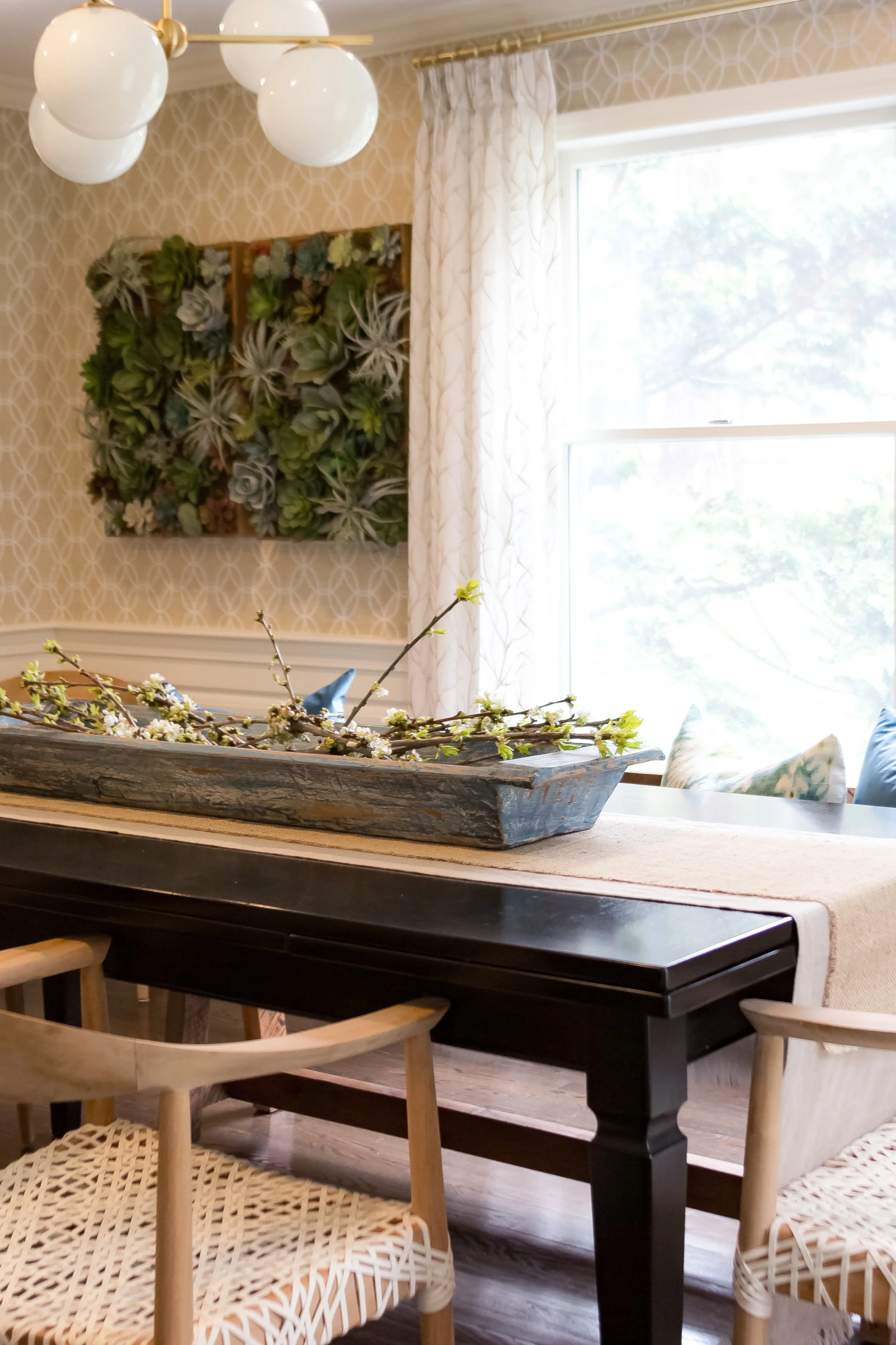 Duxbury Antique wood dining table with plants and blanket on chair by Lark and Soul interior design