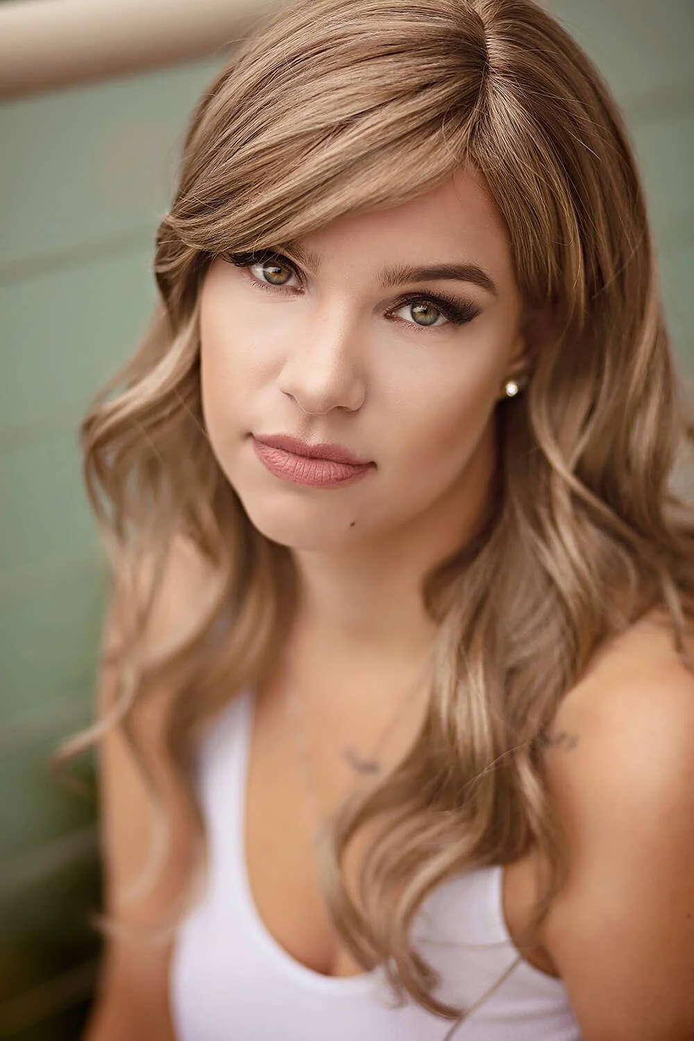 Woman with professional hair and makeup before her boudoir photography session