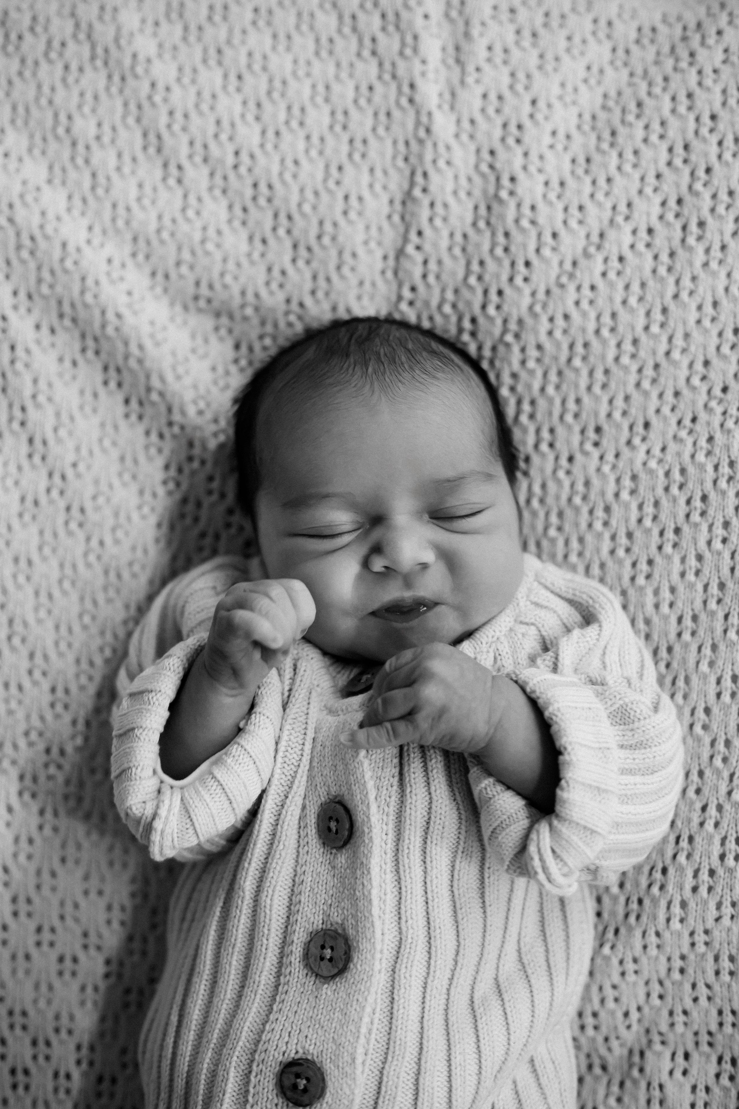 Newborn baby sleeping peacefully in hospital cot during a Fresh 48 newborn photography session in Geelong