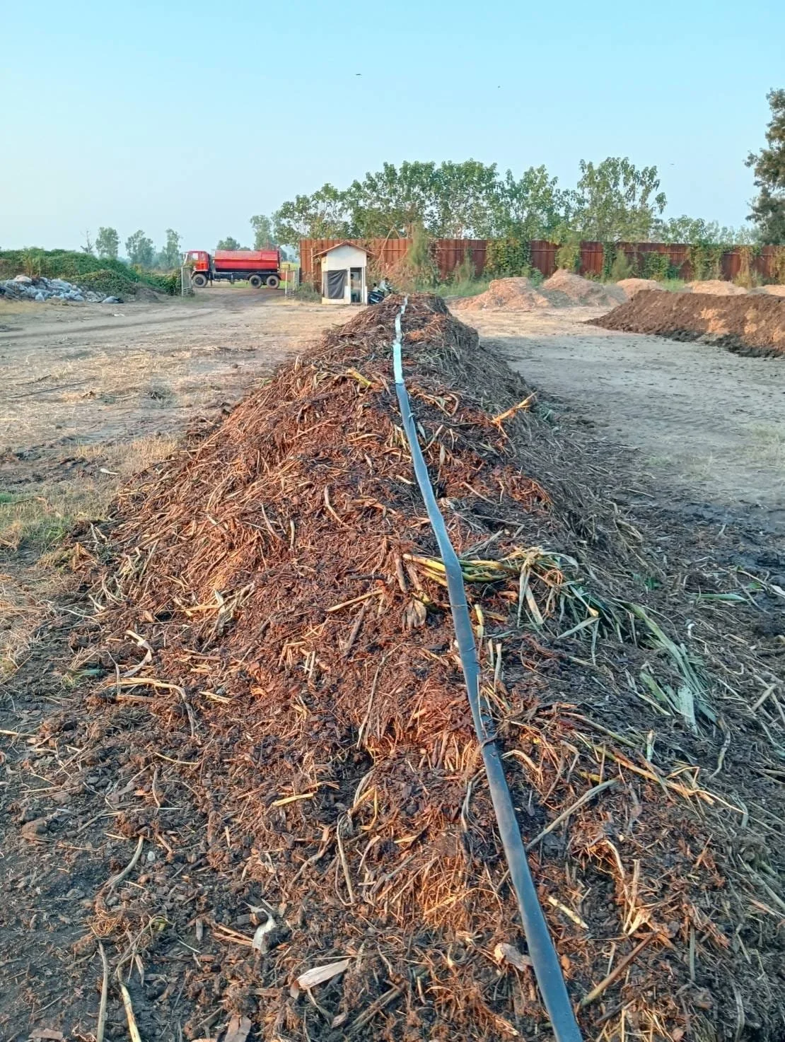 Irrigation line along the top of the compost windrow to ensure sufficient moisture is maintained to keep the biology happy. Image provided by the farm team.