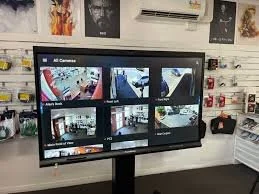 A digital security monitor showing multiple surveillance camera feeds inside a store.