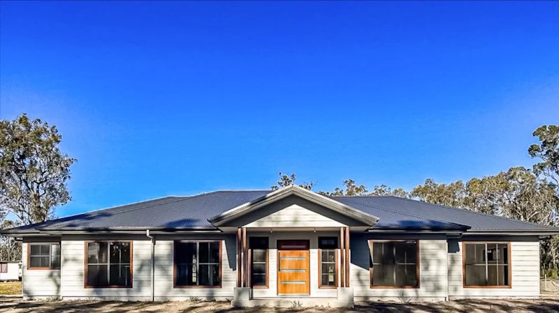 Front facade of a new home build by Mincove Homes with blue sky and trees