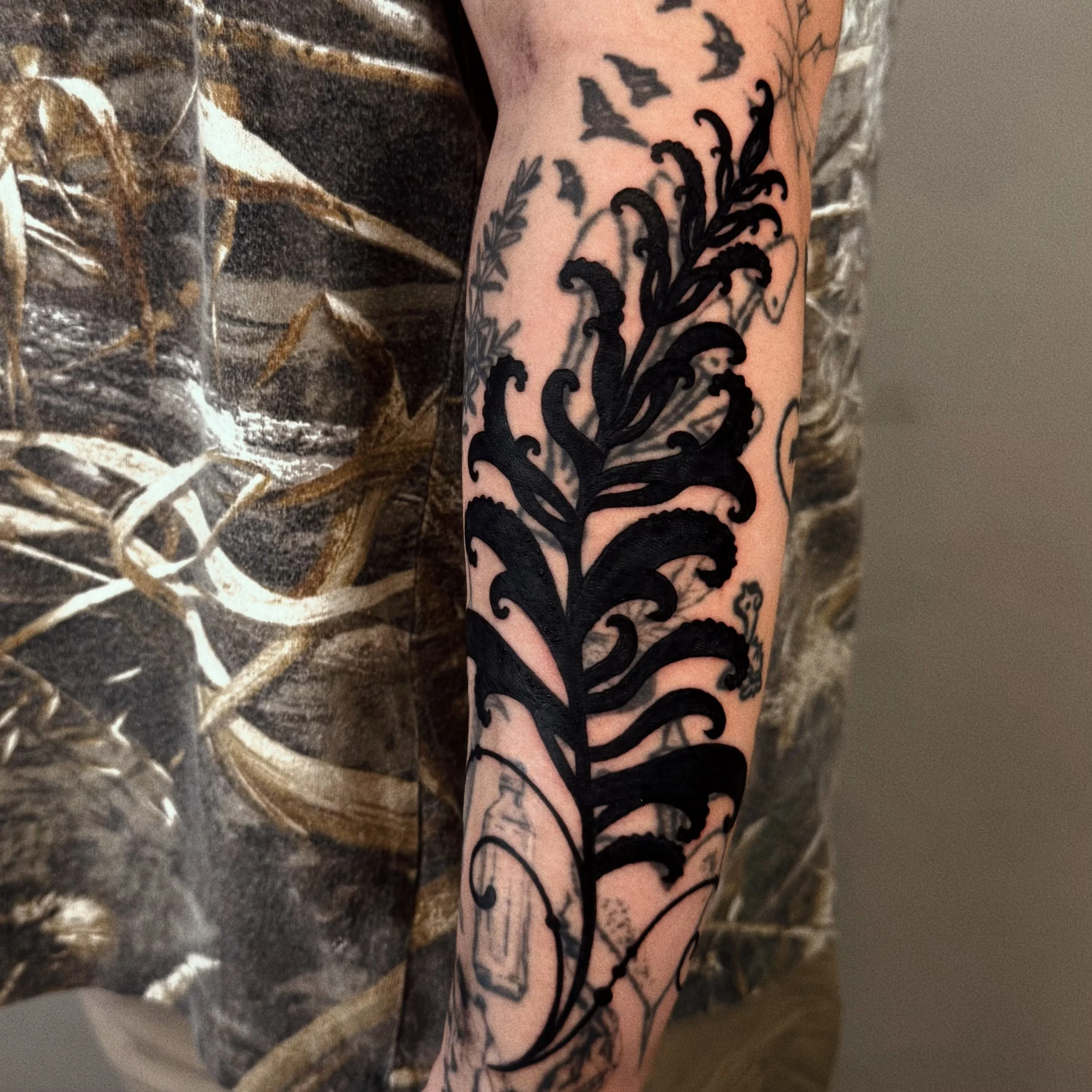 fern blackwork tattoo blastover