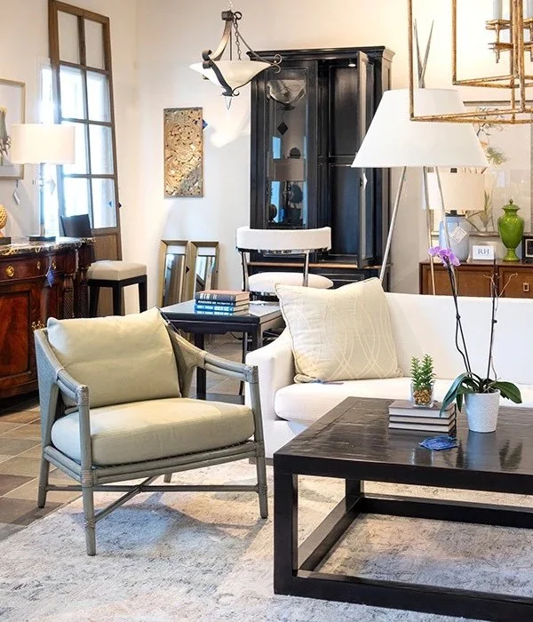 Consignment shop full of chairs light fixtures couches coffee tables and art at the Furniture Consignment Gallery in Massachusetts