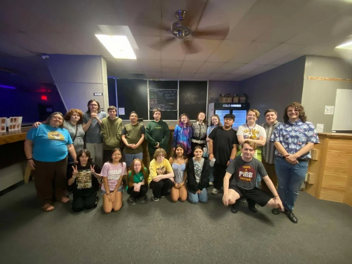 A group of youth of various ages, races, and genders along with their adult leaders.