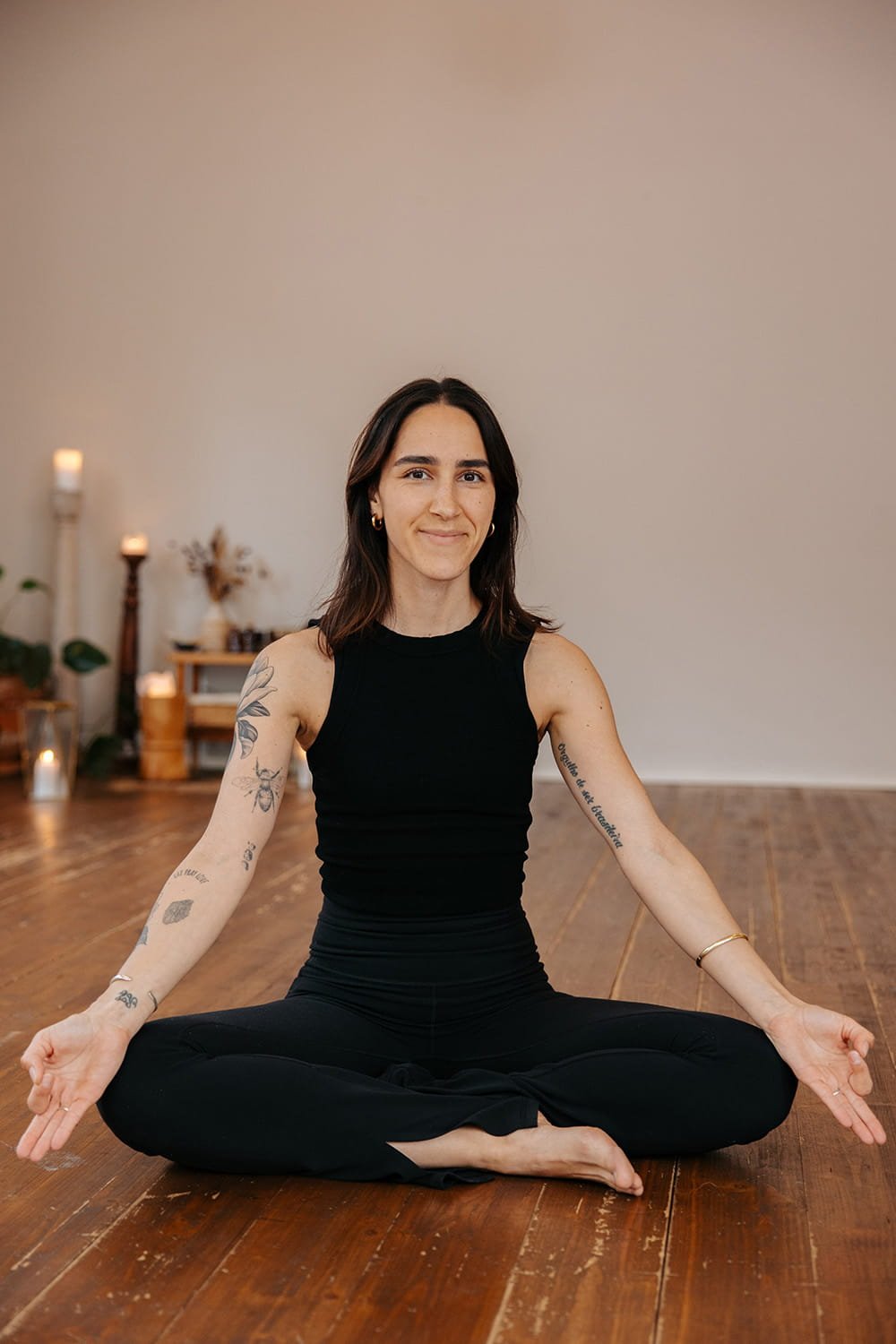 Jil Bianca sitting in her studio, showing her focus on somatic movement, mobility practices, pilates, yoga and breath.