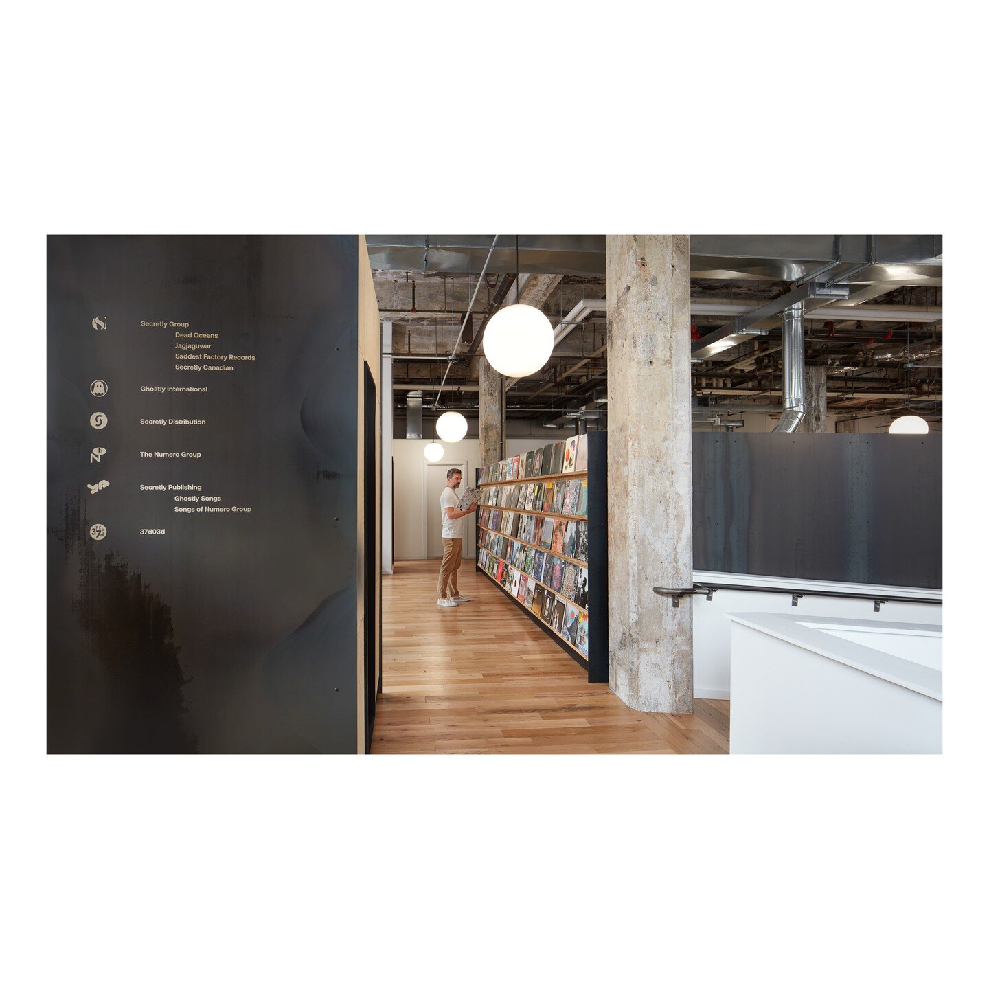 Entry and vinyl library of @secretlygroup artists at their new Williamsburg office. 📷: @ashoksinhaphoto. @jagjaguwar @deadoceans @secretlycanadian #officedesign #williamsburg #brooklyn #hotrolledsteel #rawconcrete #tectum
