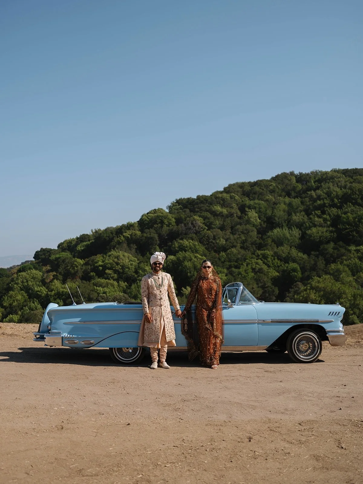Why settle for one main dining tent when you can create an experience with three? 

For this private estate wedding, we designed distinct spaces for guest arrival and the Baraat assembly, complete with a vintage sky-blue Chevy convertible for a show-
