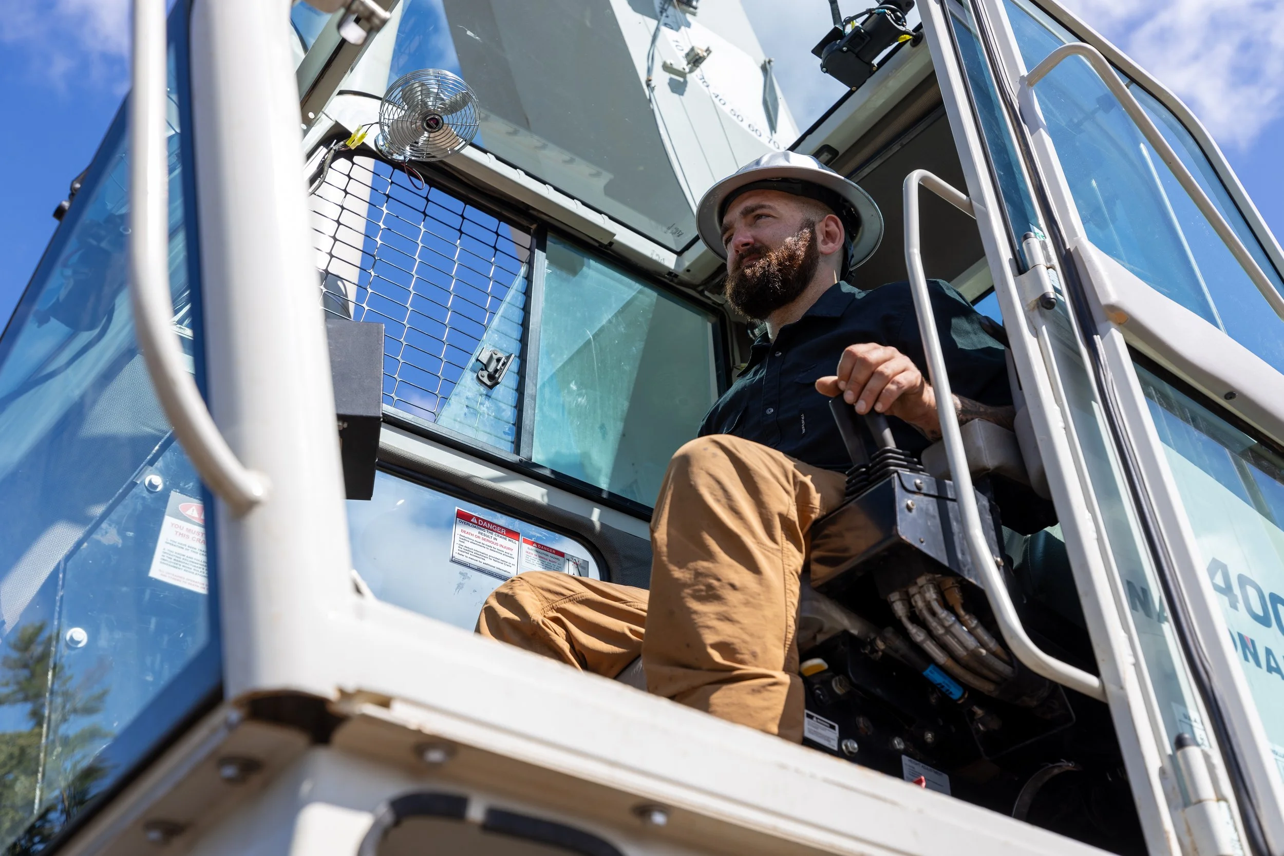 Brendan, the owner of Taylor Tree Service, Operating a crane on a tree removal job in Portsmouth New Hampshire.