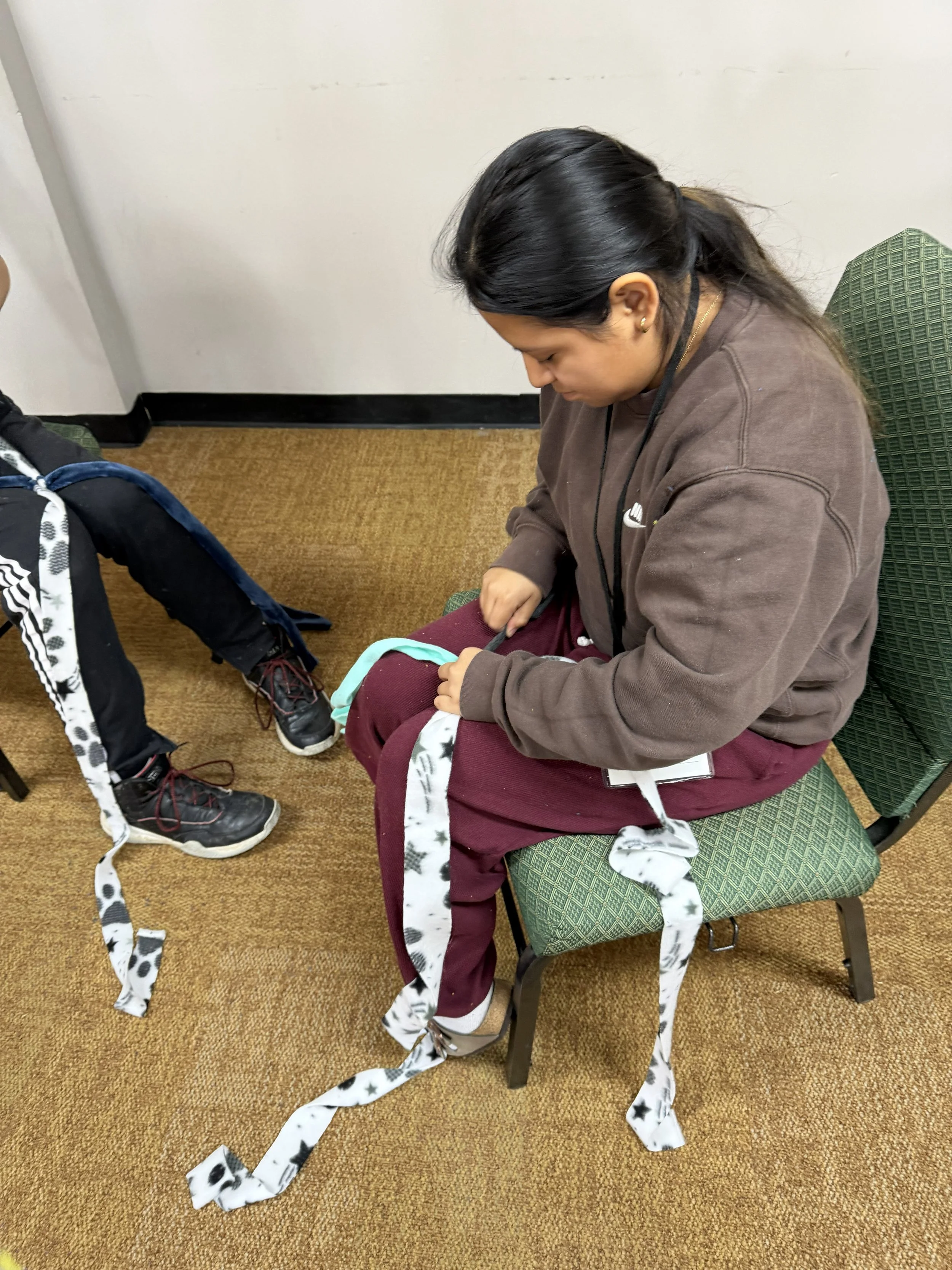 Melissa making toys for shelter dogs at Winter Youth Retreat 2026