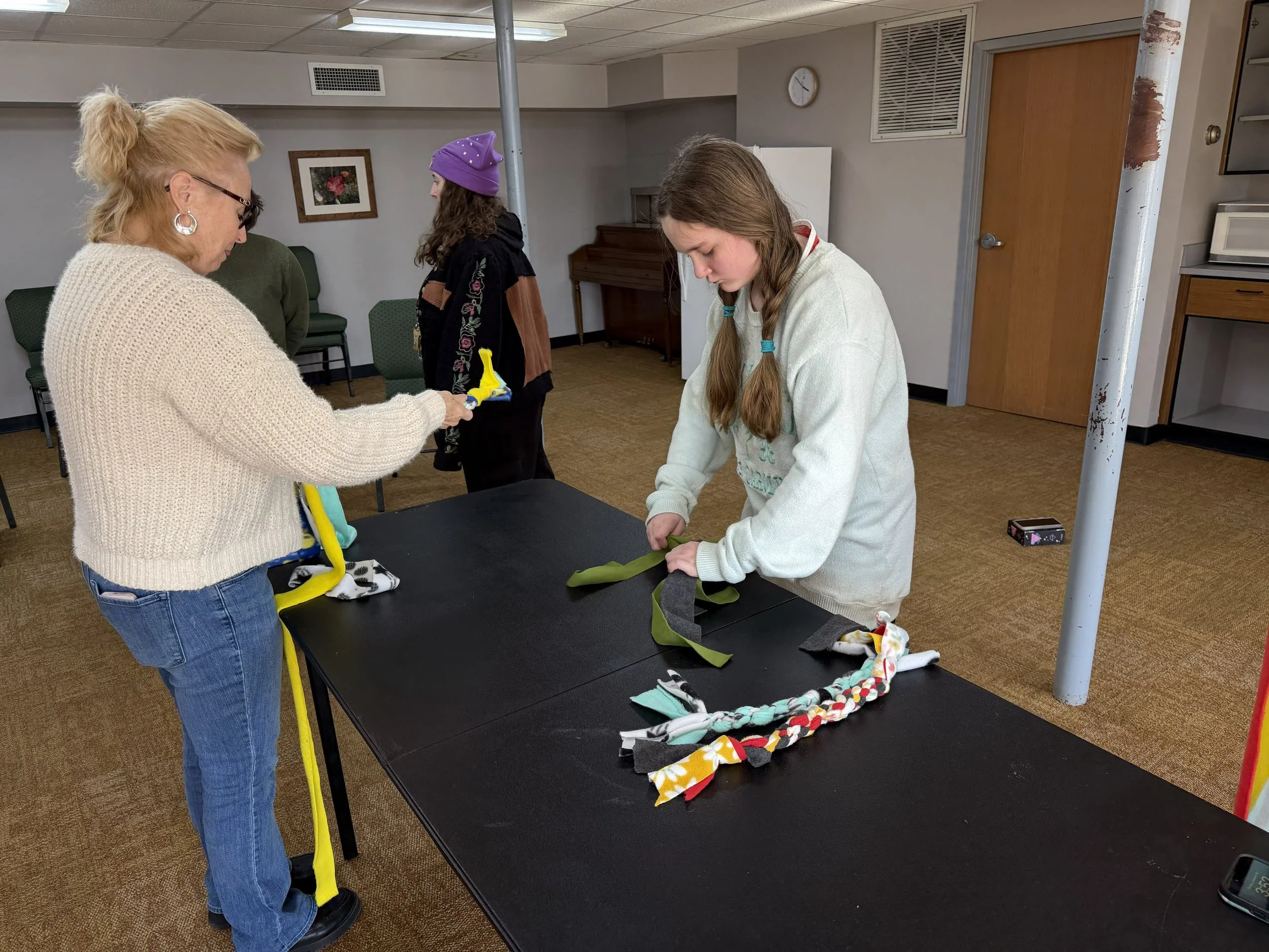 Pastor Tonya and Amy making toys for shelter dogs in Blowing Rock NC (Amelia in background)