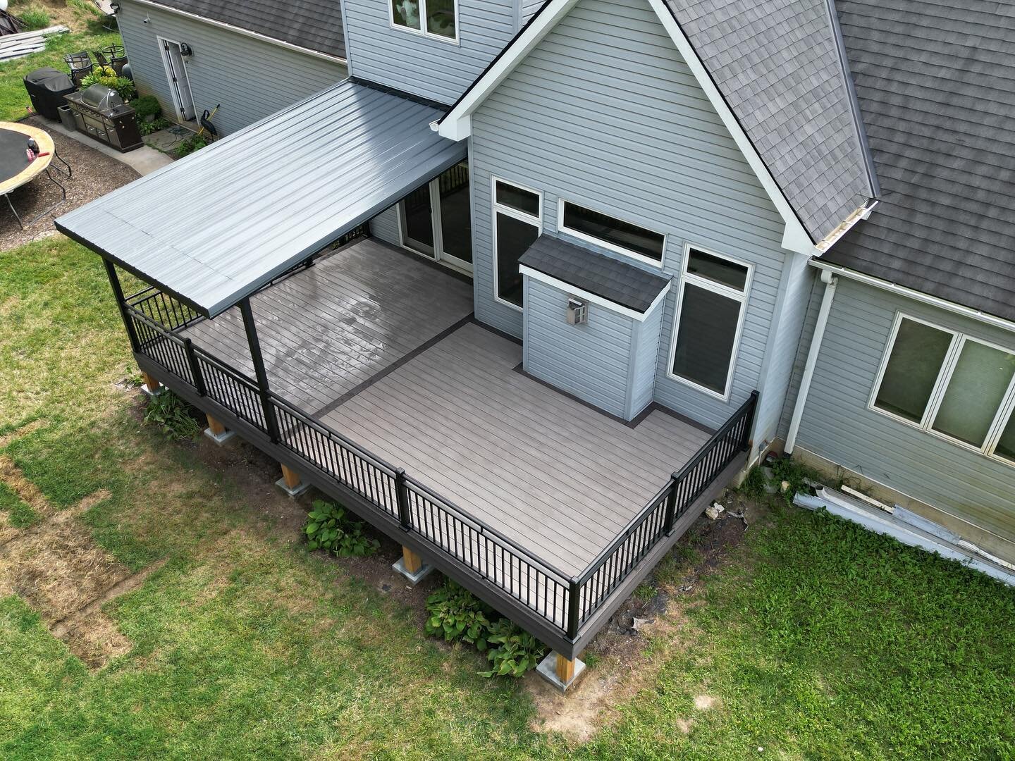 New deck with steel lean to roof&hellip;. Let&rsquo;s go. Happy customers make the hard work worth it. @jdnoojin4220 @dakotacochranemma @nawrocki_22 @michael.koperski05 @boldra @timbertech @theazekcompany @diggerspecialtiesinc @fortressbldgproducts #