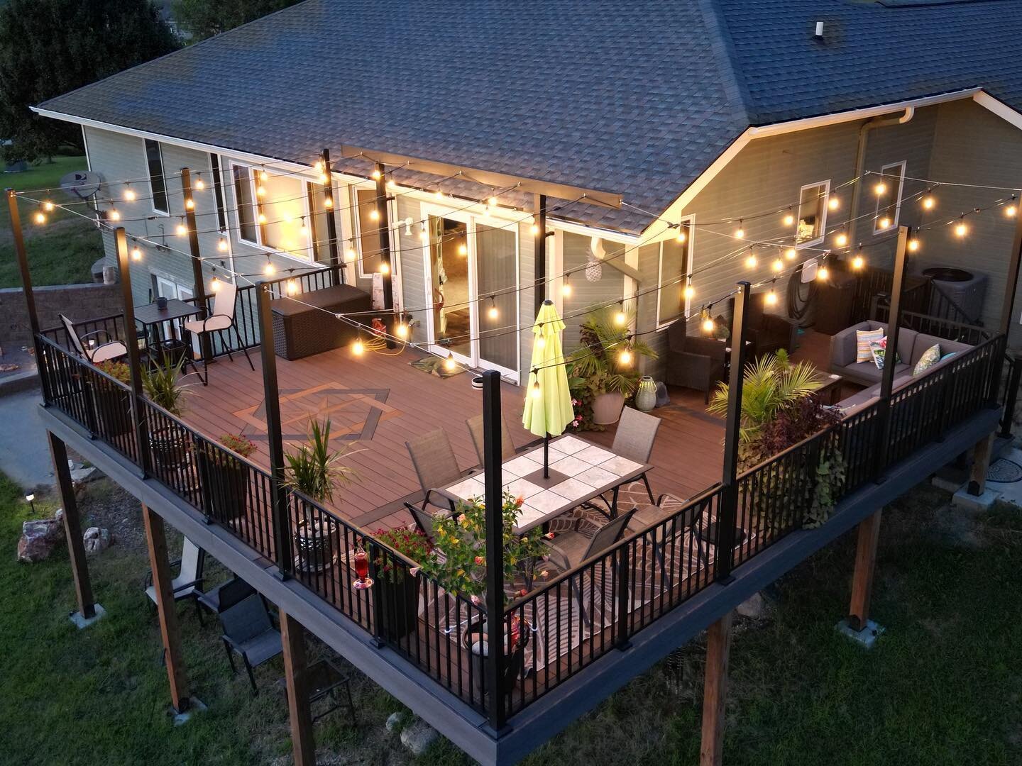 Check out the custom inlay we did on this deck!! We hand cut and built using multiple pieces of decking and worked with our customers to bring their idea to life. We used extended posts specifically made to accommodate the patio lighting, and a Hidea