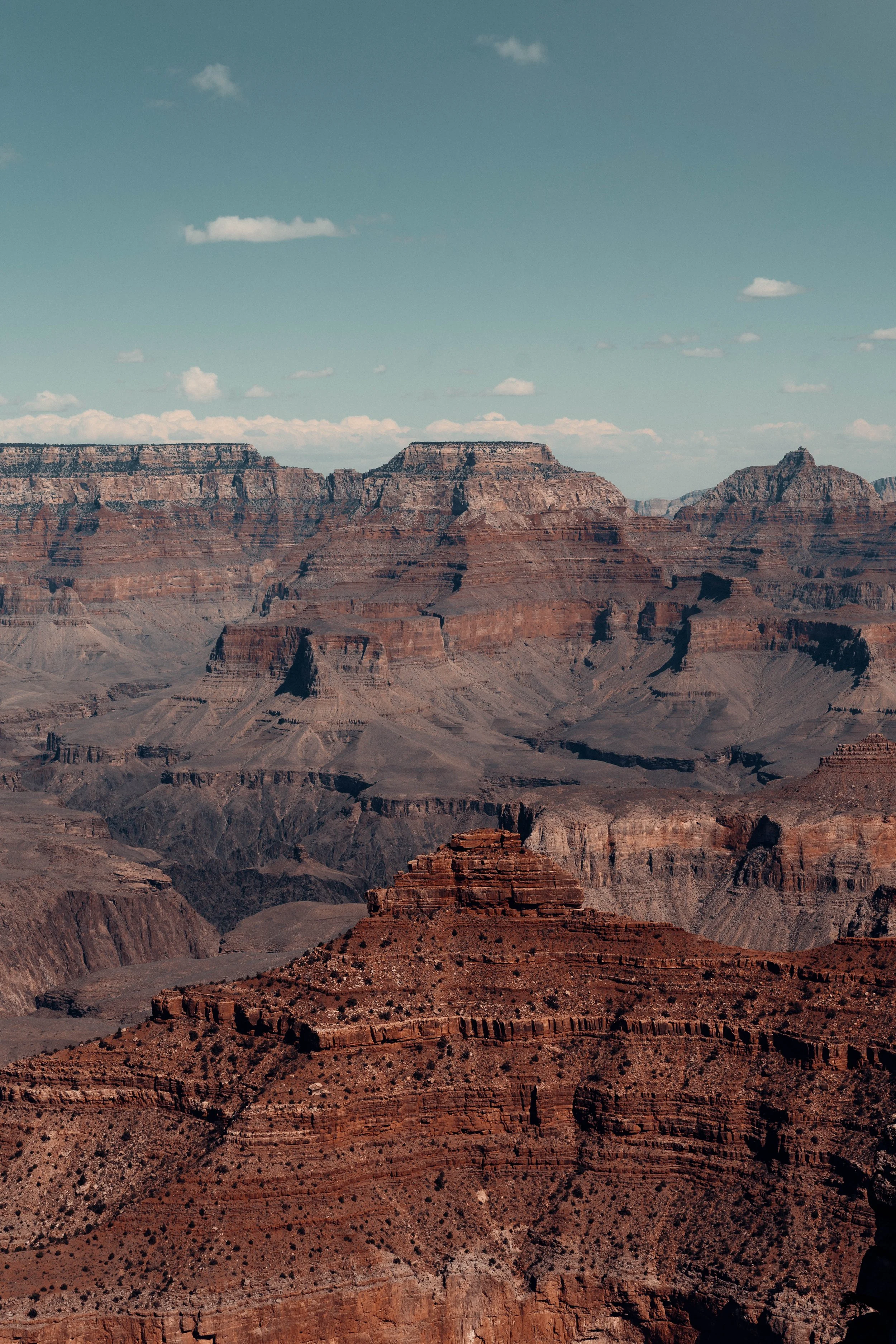 Grand Canyon landscape with layered rock formations and clear sky.