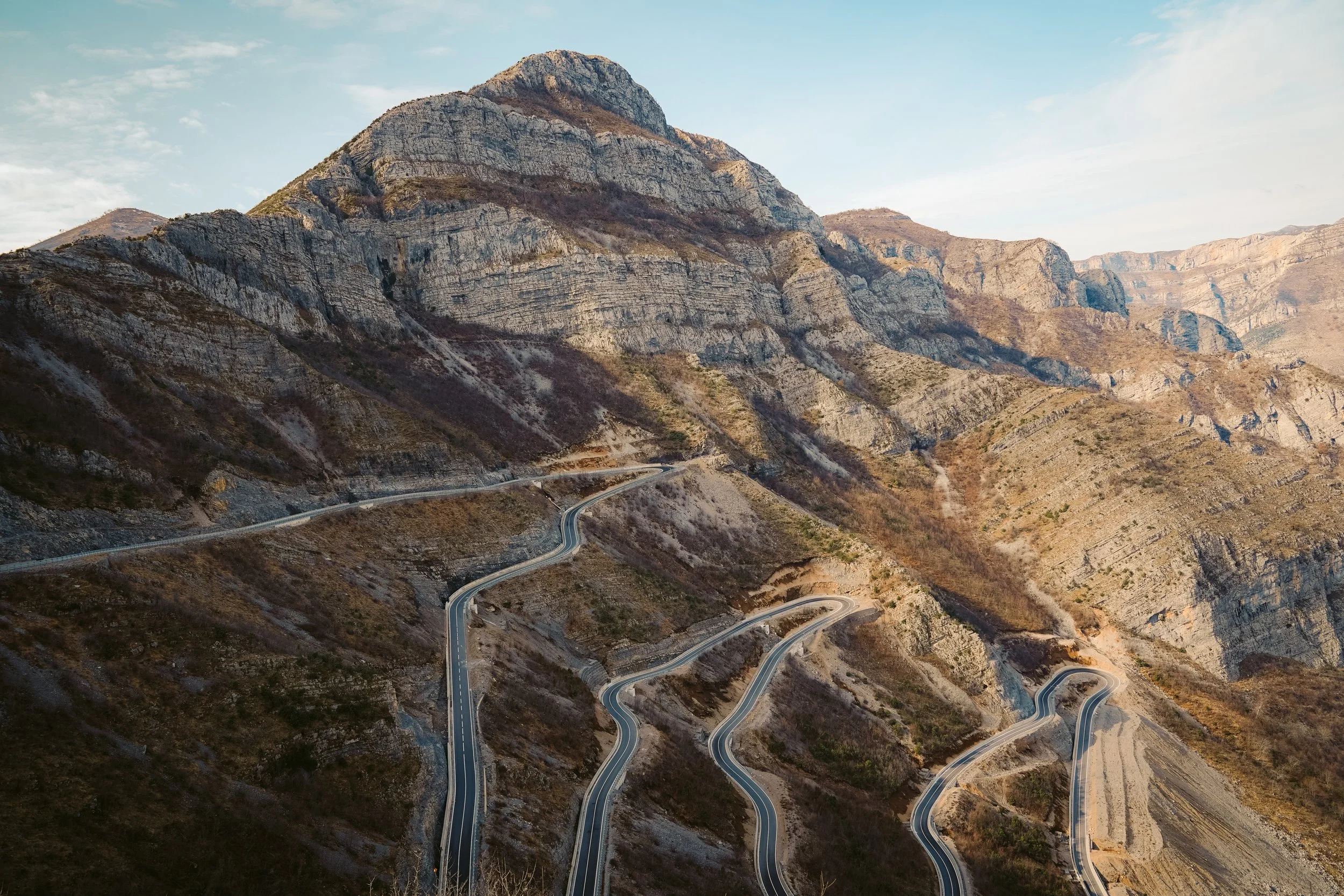 Mountain road with sharp curves and rocky terrain
