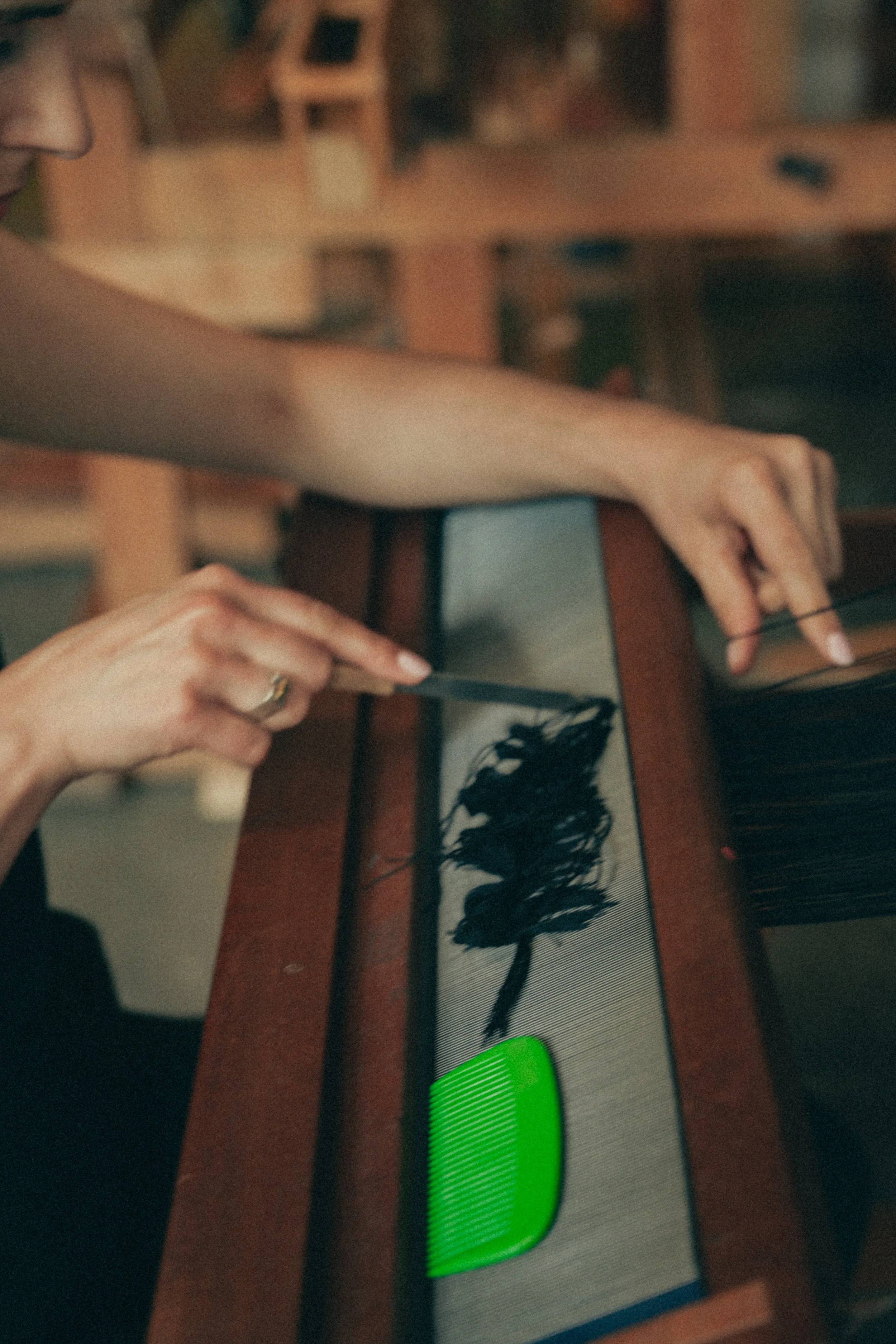 Hands setting up pattern loom