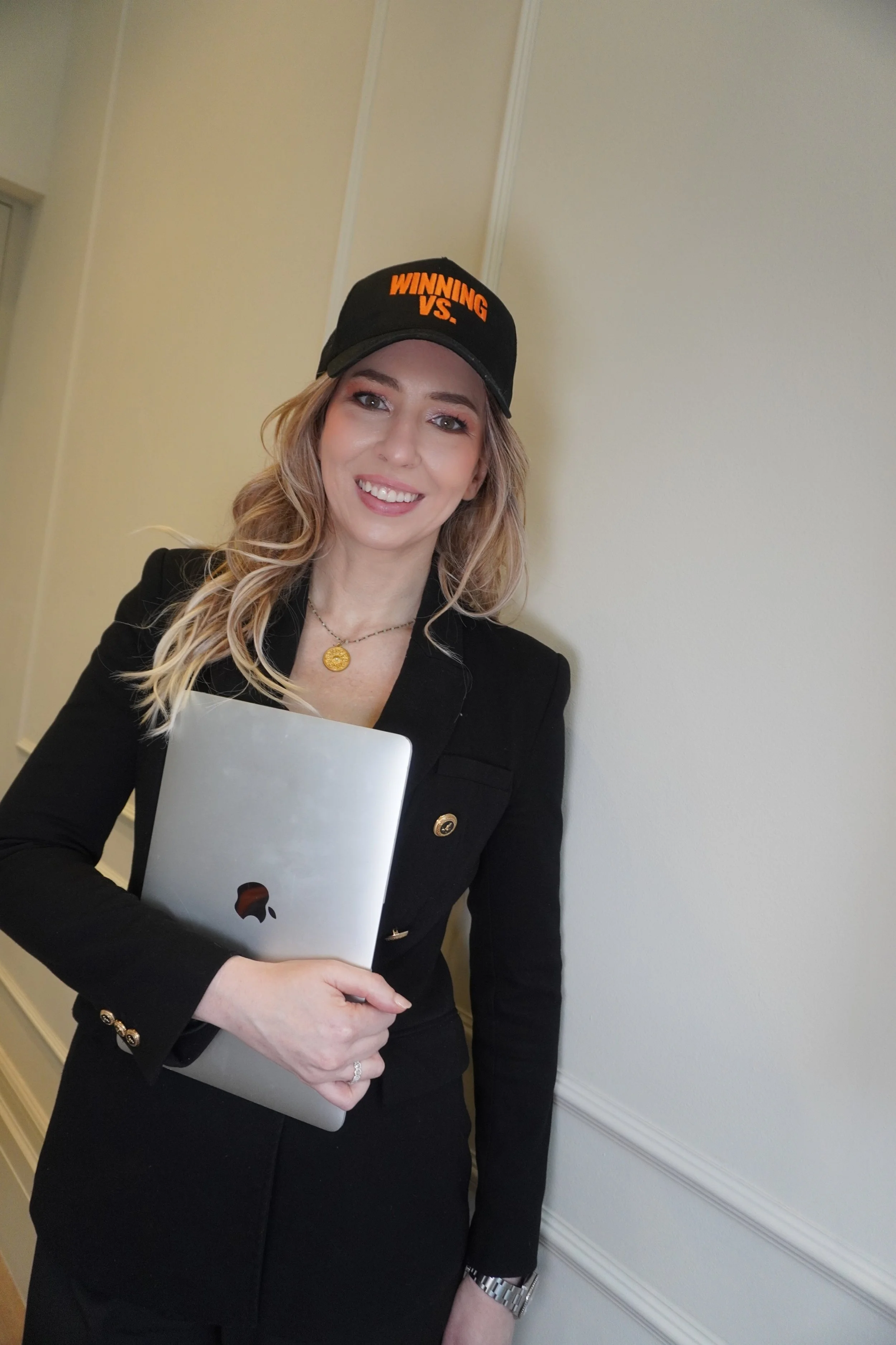 Lisa Winning, story telling and media strategist and founder of Winning VS, holding a laptop