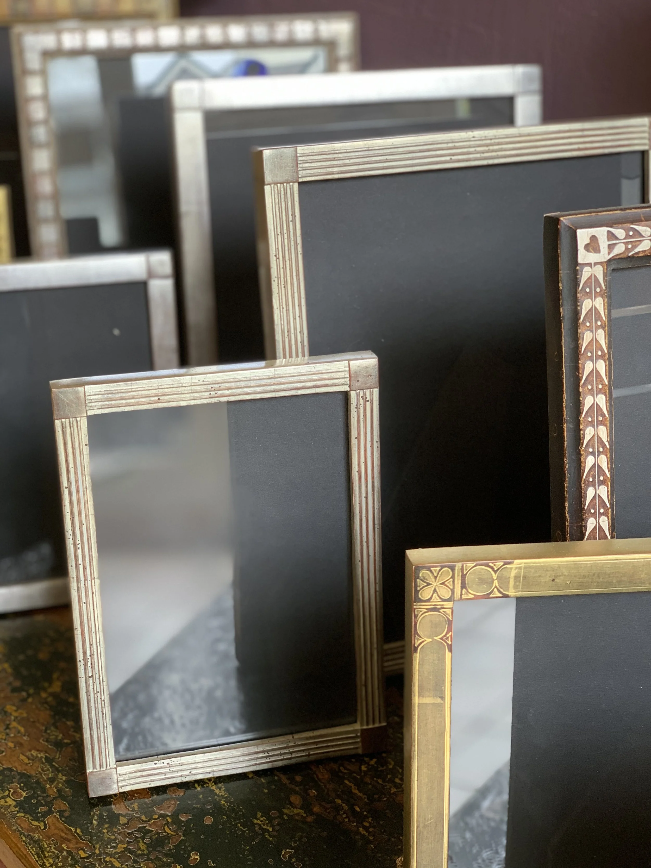 A close-up arrangement of multiple hand made Croatian picture frames, perfect for family photos.