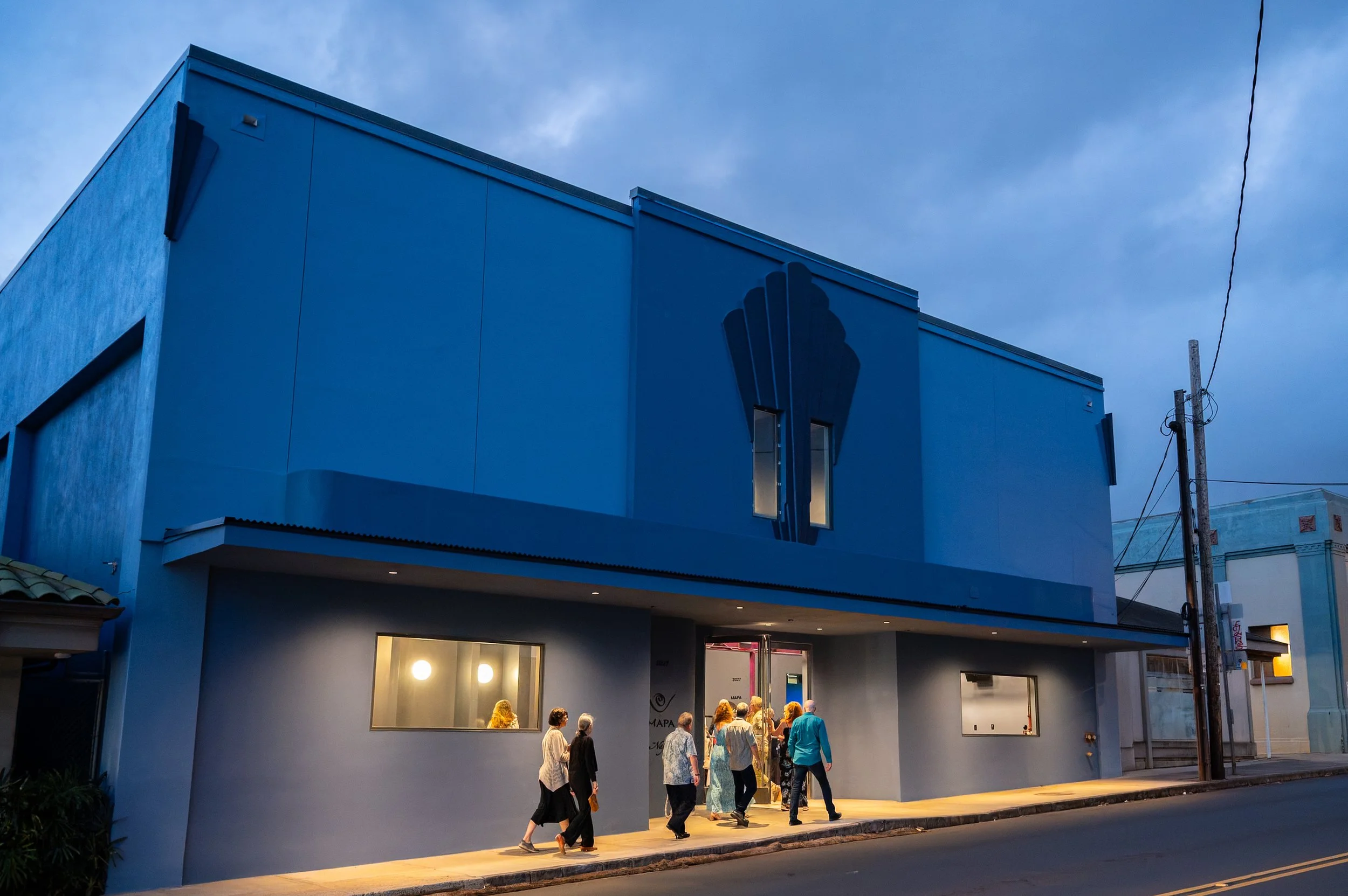 photo of exterior of blue building at night