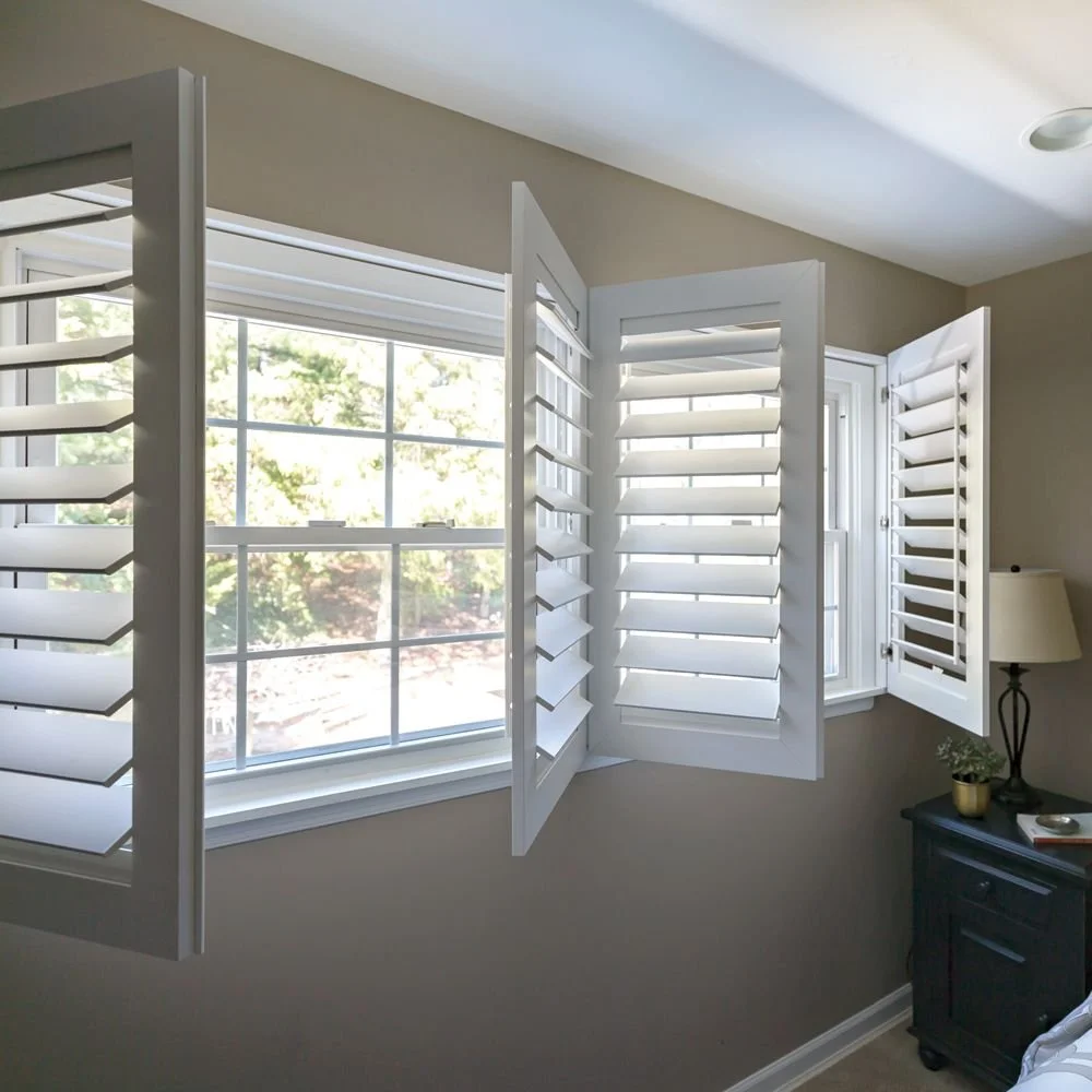 A bedroom and a window with white shutters about quality and durability