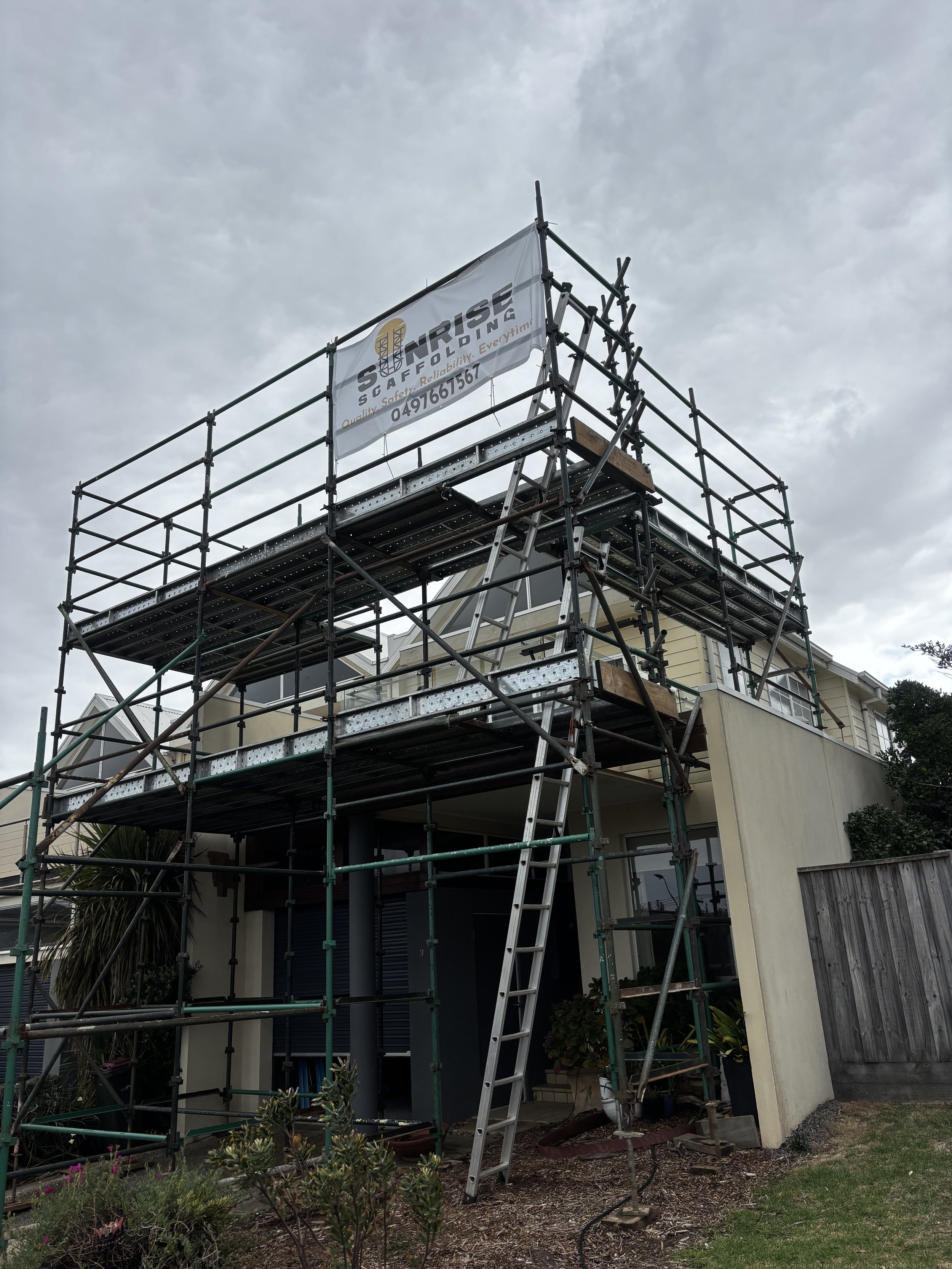 Scaffold hire setup with edge protection and working platform on a commercial build