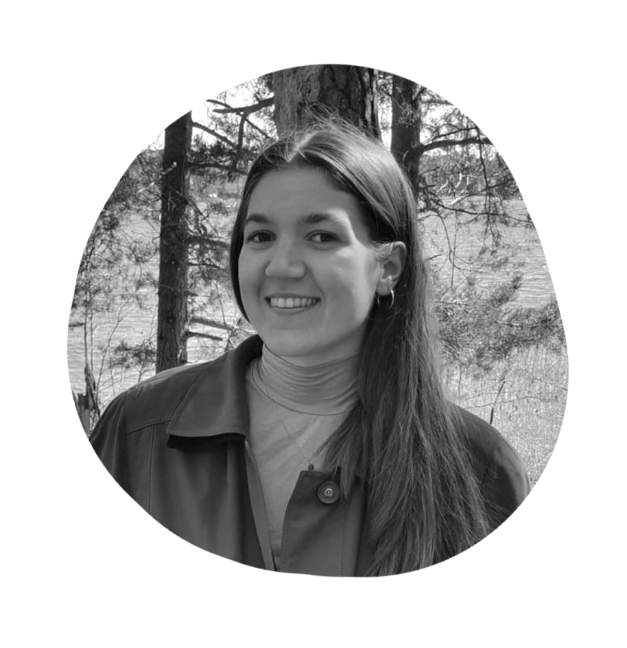 Smiling black and white photo of Iina Santamäki in natural setting.