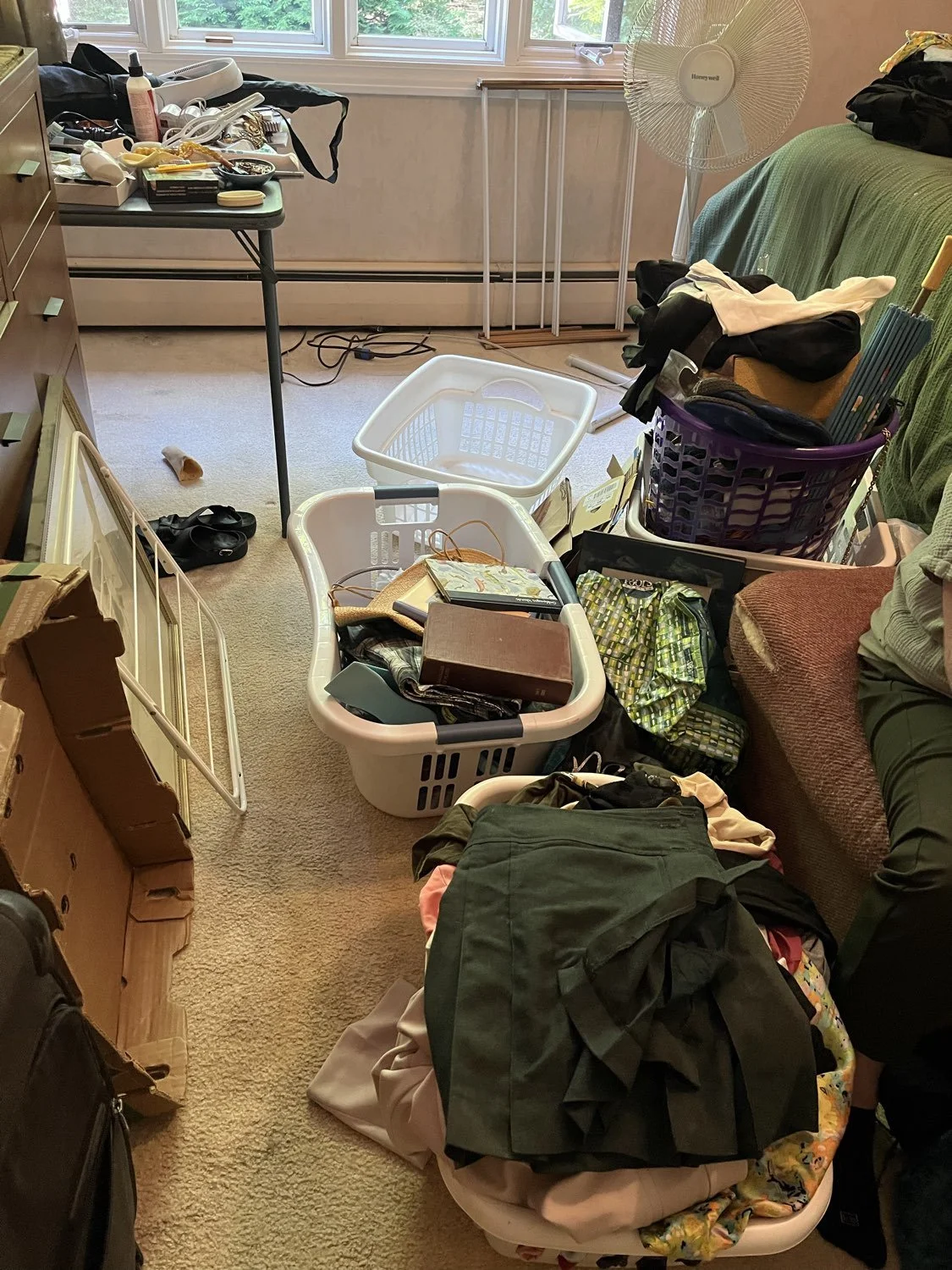 laundry baskets and laundry clutter on the floor in a bedroom in Moreland Hills, Ohio before decluttering