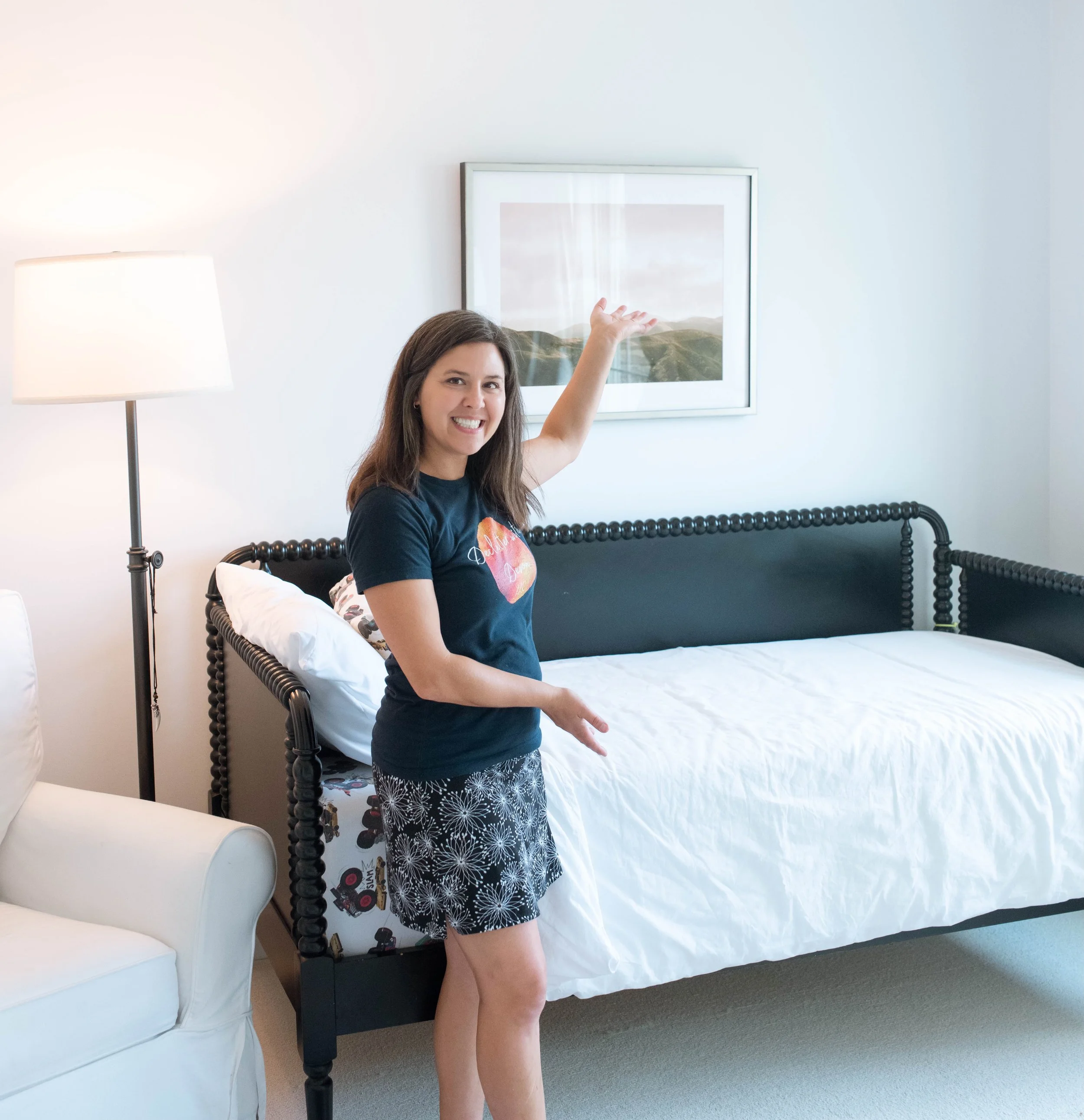 Devon smiling and showing clean and tidy bed